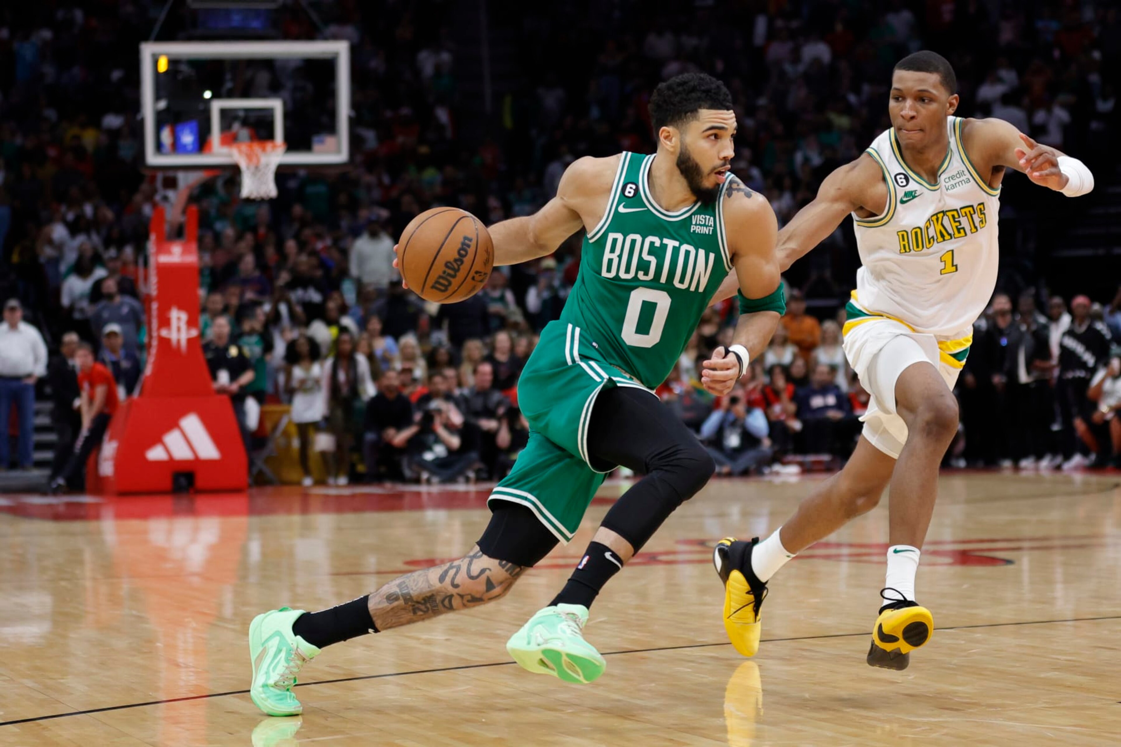 HOUSTON, TEXAS - MARCH 13: Jayson Tatum #0 of the Boston Celtics drives to the net ahead of Jabari Smith Jr. #1 of the Houston Rockets during the second half at Toyota Center on March 13, 2023 in Houston, Texas. NOTE TO USER: User expressly acknowledges and agrees that, by downloading and or using this photograph, User is consenting to the terms and conditions of the Getty Images License Agreement. (Photo by Carmen Mandato/Getty Images)