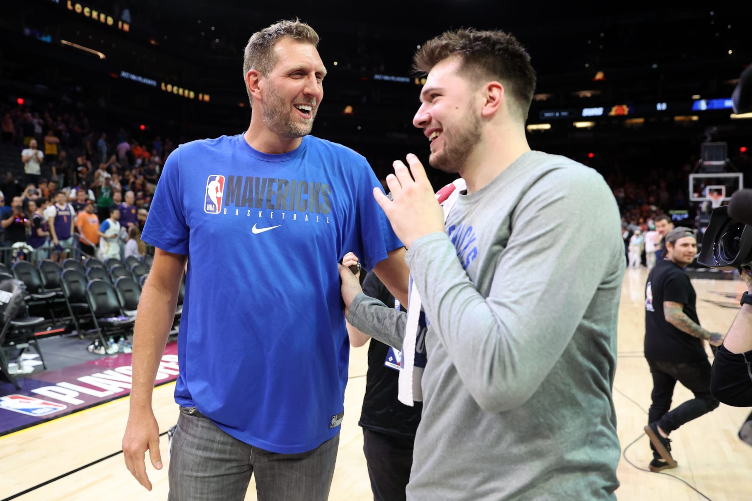 PHOENIX, ARIZONA - MAY 15: Former Dallas Mavericks player Dirk Nowitzki talks with Luka Doncic #77 of the Dallas Mavericks after the Mavericks defeated the Suns 123-90 in Game Seven of the 2022 NBA Playoffs Western Conference Semifinals at Footprint Center on May 15, 2022 in Phoenix, Arizona. NOTE TO USER: User expressly acknowledges and agrees that, by downloading and/or using this photograph, User is consenting to the terms and conditions of the Getty Images License Agreement. (Photo by Christian Petersen/Getty Images)