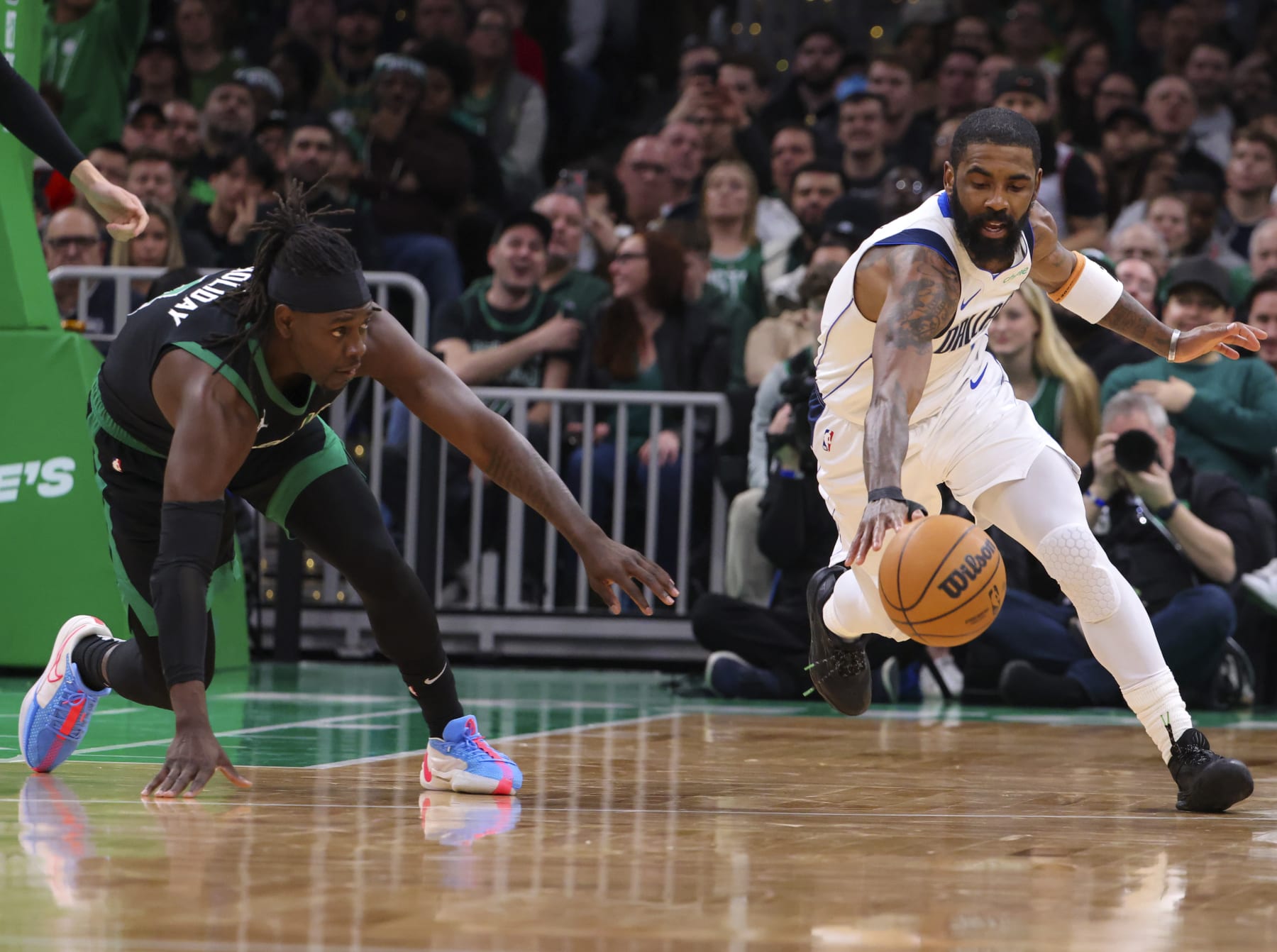 Boston, MA - March 1: Dallas Mavericks guard Kyrie Irving recovers a loose ball in front of Boston Celtics guard Jrue Holiday in the second quarter. The Celtics beat the Mavericks, 138-110. (Photo by Matthew J. Lee/The Boston Globe via Getty Images)