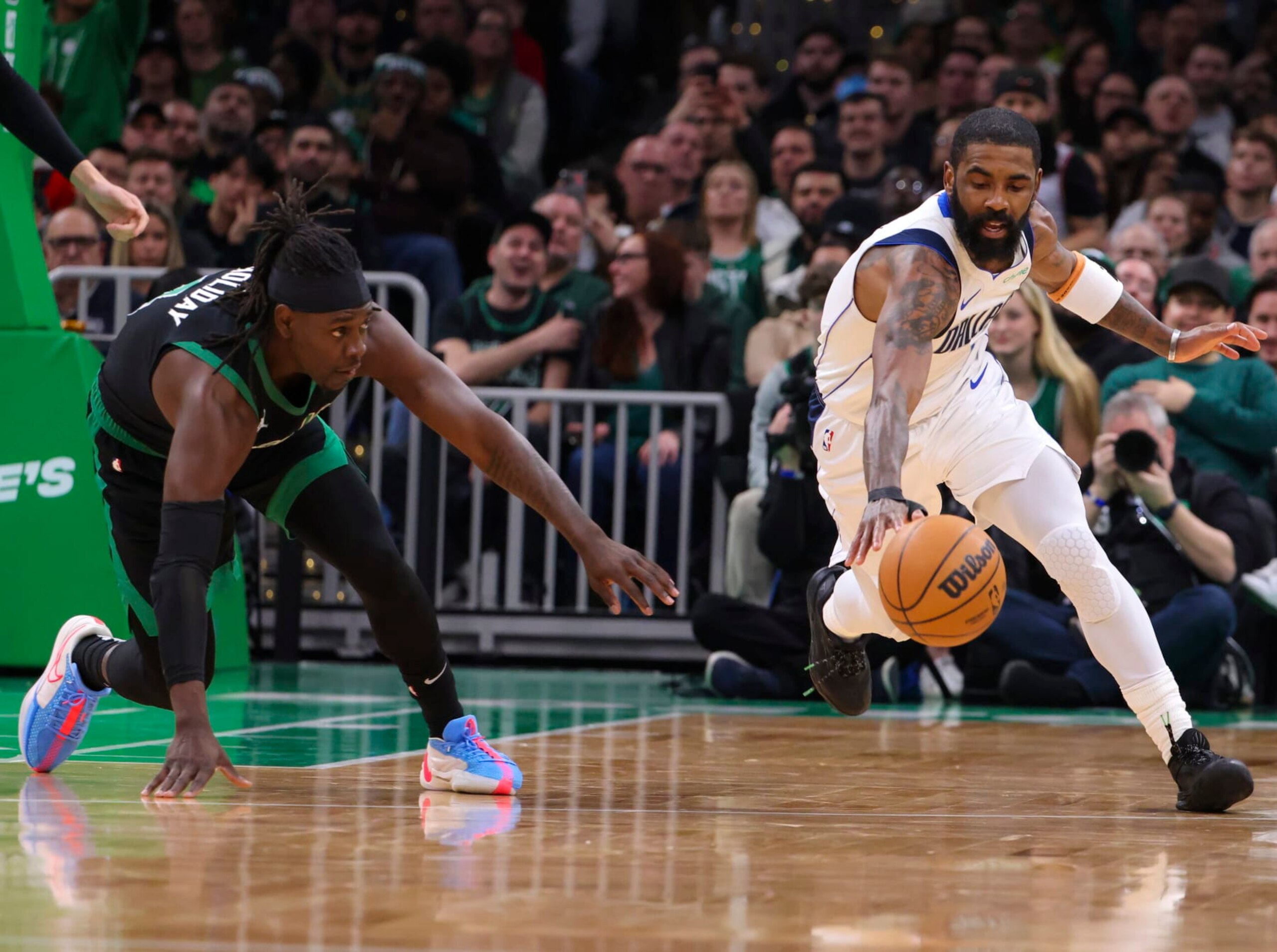 Boston, MA - March 1: Dallas Mavericks guard Kyrie Irving recovers a loose ball in front of Boston Celtics guard Jrue Holiday in the second quarter. The Celtics beat the Mavericks, 138-110. (Photo by Matthew J. Lee/The Boston Globe via Getty Images)