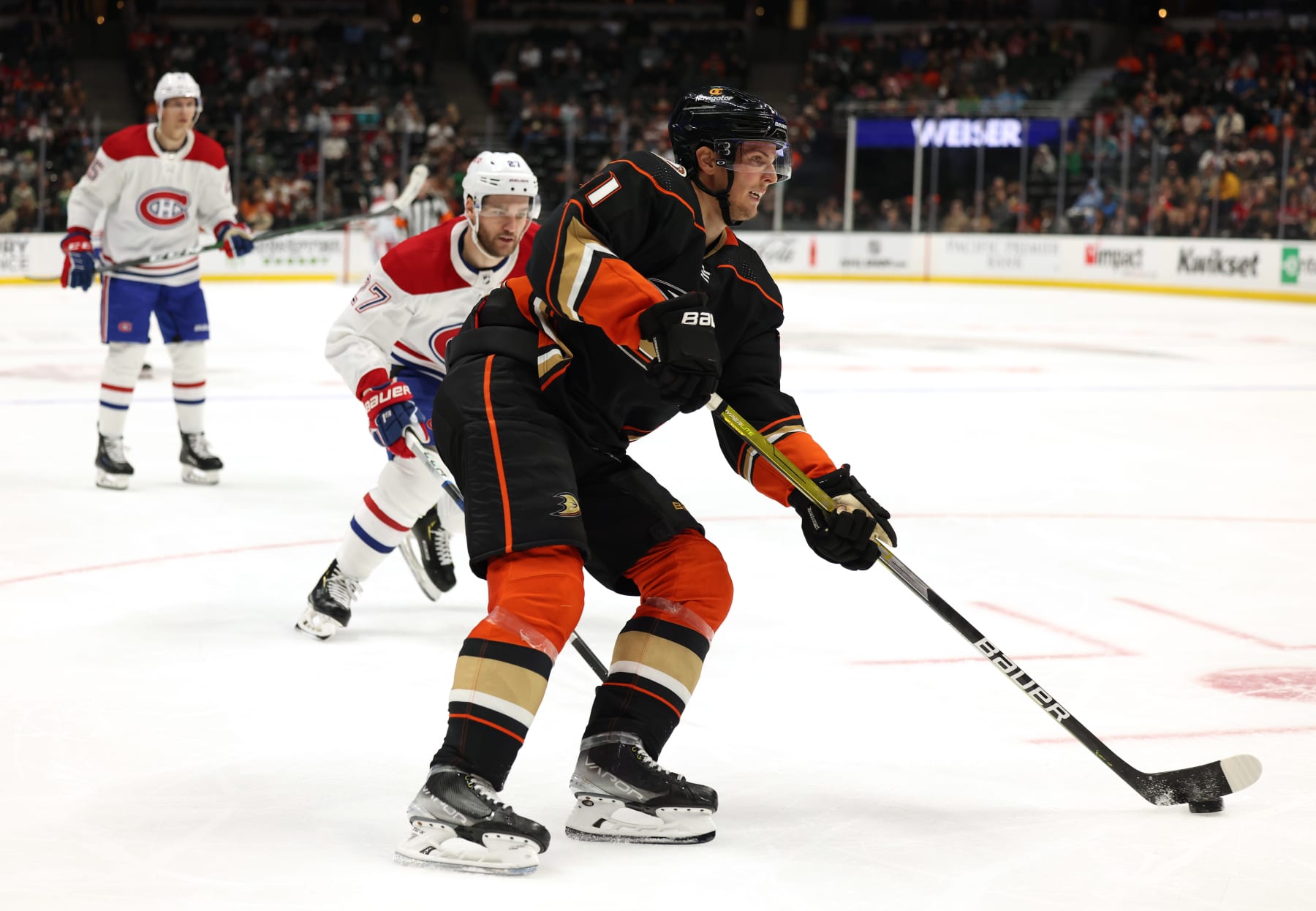 ANAHEIM, CALIFORNIA - MARCH 03: Trevor Zegras #11 of the Anaheim Ducks passes in front of Jonathan Drouin #27 of the Montreal Canadiens during a 3-2 Ducks win at Honda Center on March 03, 2023 in Anaheim, California. (Photo by Harry How/Getty Images)