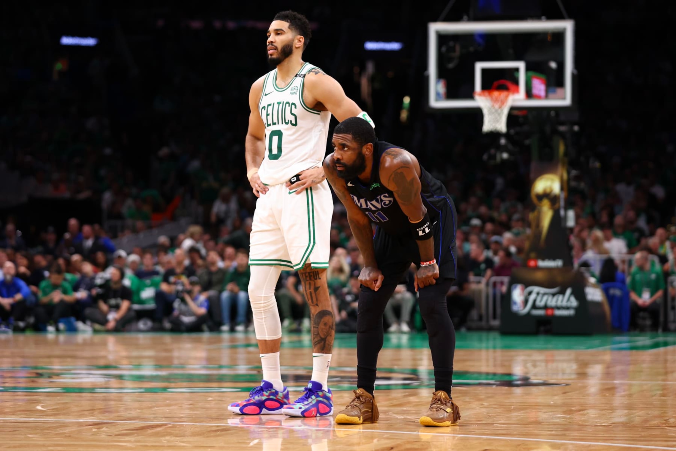 BOSTON, MASSACHUSETTS - JUNE 06: Kyrie Irving #11 of the Dallas Mavericks and Jayson Tatum #0 of the Boston Celtics look on during the second quarter in Game One of the 2024 NBA Finals at TD Garden on June 06, 2024 in Boston, Massachusetts. NOTE TO USER: User expressly acknowledges and agrees that, by downloading and or using this photograph, User is consenting to the terms and conditions of the Getty Images License Agreement. (Photo by Maddie Meyer/Getty Images)