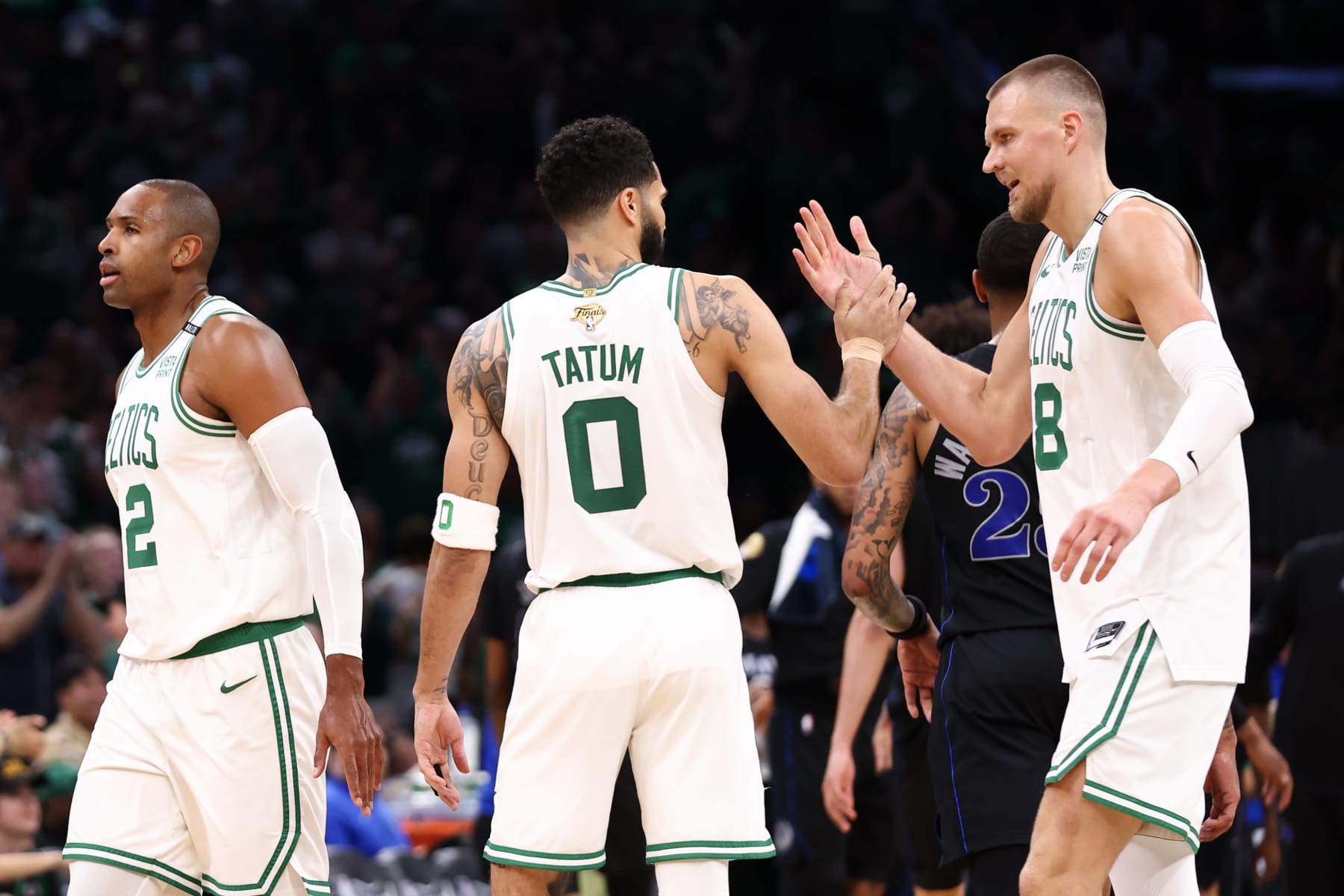 BOSTON, MASSACHUSETTS - JUNE 06: Kristaps Porzingis #8 of the Boston Celtics celebrates with Jayson Tatum #0 during the second quarter against the Dallas Mavericks in Game One of the 2024 NBA Finals at TD Garden on June 06, 2024 in Boston, Massachusetts. NOTE TO USER: User expressly acknowledges and agrees that, by downloading and or using this photograph, User is consenting to the terms and conditions of the Getty Images License Agreement. (Photo by Maddie Meyer/Getty Images)