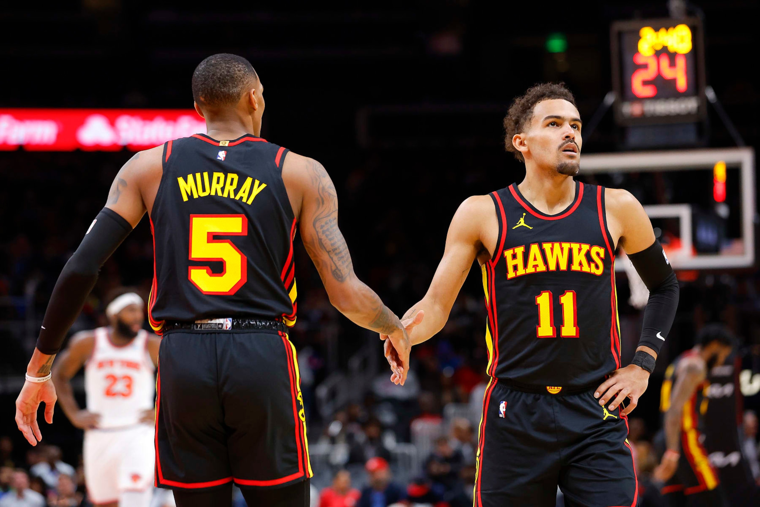 ATLANTA, GEORGIA - NOVEMBER 15: Trae Young #11 reacts with Dejounte Murray #5 of the Atlanta Hawks during the first half against the New York Knicks at State Farm Arena on November 15, 2023 in Atlanta, Georgia. NOTE TO USER: User expressly acknowledges and agrees that, by downloading and or using this photograph, User is consenting to the terms and conditions of the Getty Images License Agreement. (Photo by Todd Kirkland/Getty Images) ATLANTA, GEORGIA - NOVEMBER 15: Trae Young #11 reacts with Dejounte Murray #5 of the Atlanta Hawks during the first half against the New York Knicks at State Farm Arena on November 15, 2023 in Atlanta, Georgia. NOTE TO USER: User expressly acknowledges and agrees that, by downloading and or using this photograph, User is consenting to the terms and conditions of the Getty Images License Agreement. (Photo by Todd Kirkland/Getty Images)