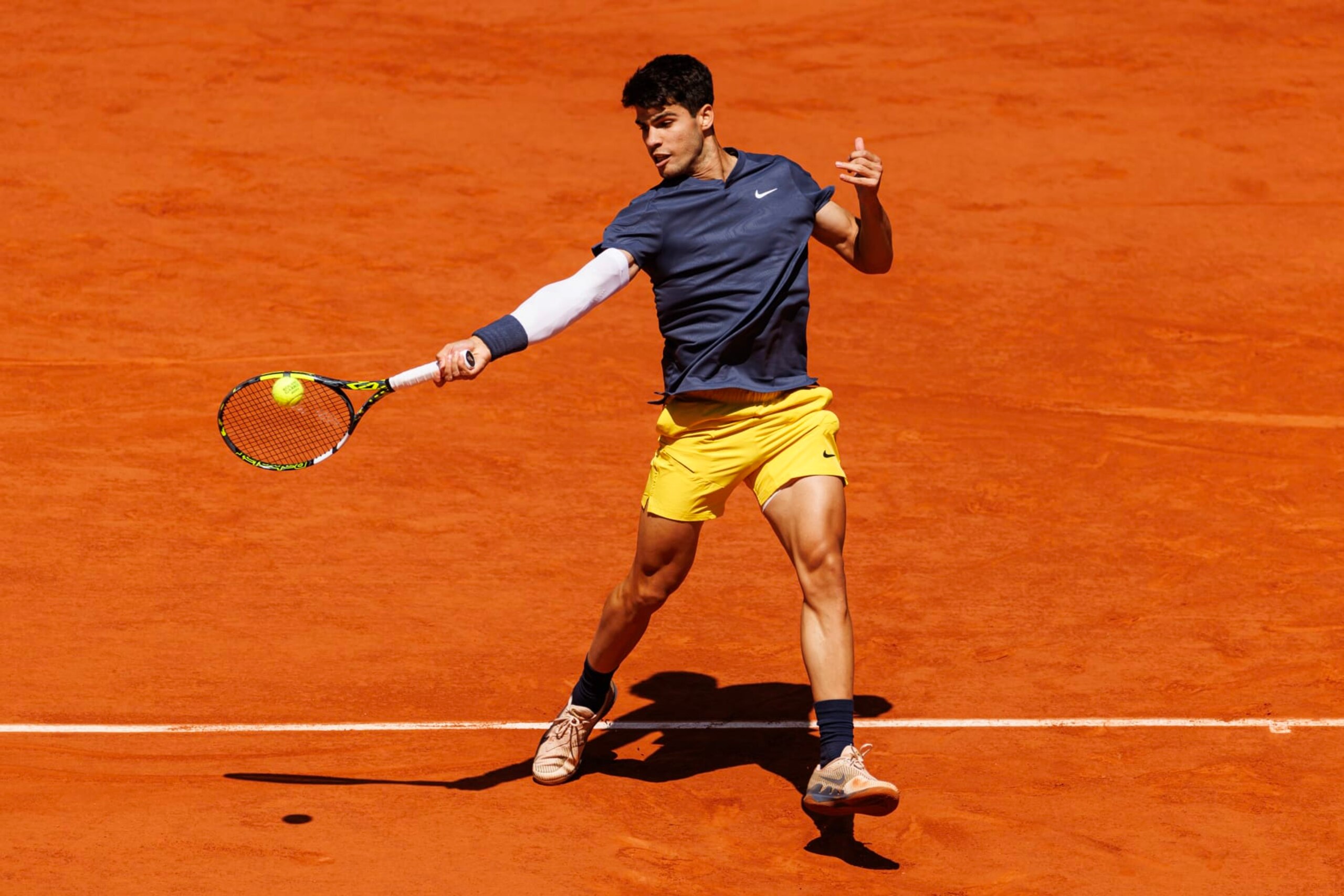 PARIS, FRANCE - JUNE 07: Carlos Alcaraz of Spain hits a forehand against Jannik Sinner of Italy in the semi-final of the men's singles at Roland Garros on June 07, 2024 in Paris, France. (Photo by Frey/TPN/Getty Images)
