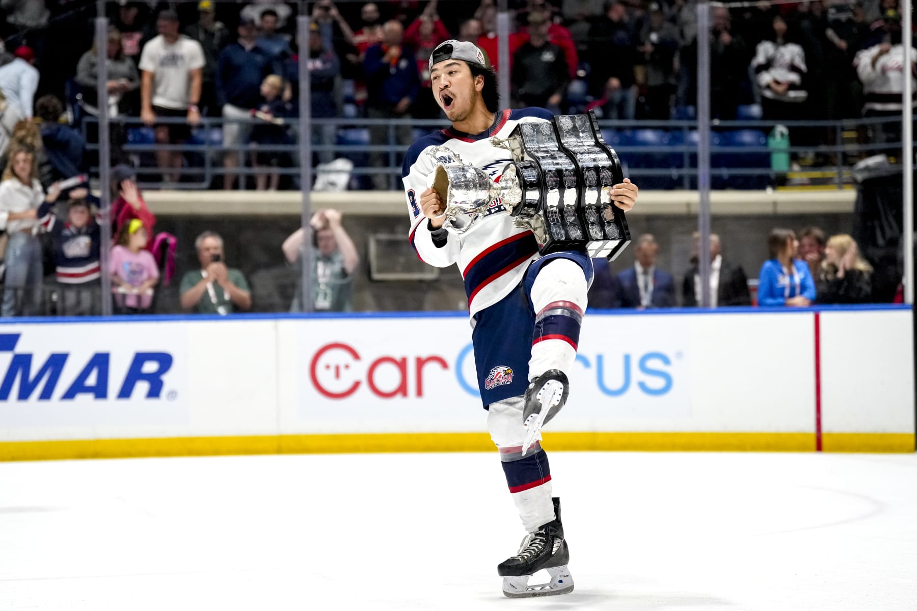 SAGINAW, MICHIGAN - JUNE 02: Zayne Parekh #19 of the Saginaw Spirit celebrates with the Memorial Cup after defeating the London Knights in the 2024 Memorial Cup Final at Dow Event Center on June 02, 2024 in Saginaw, Michigan. (Photo by Nic Antaya/Getty Images)