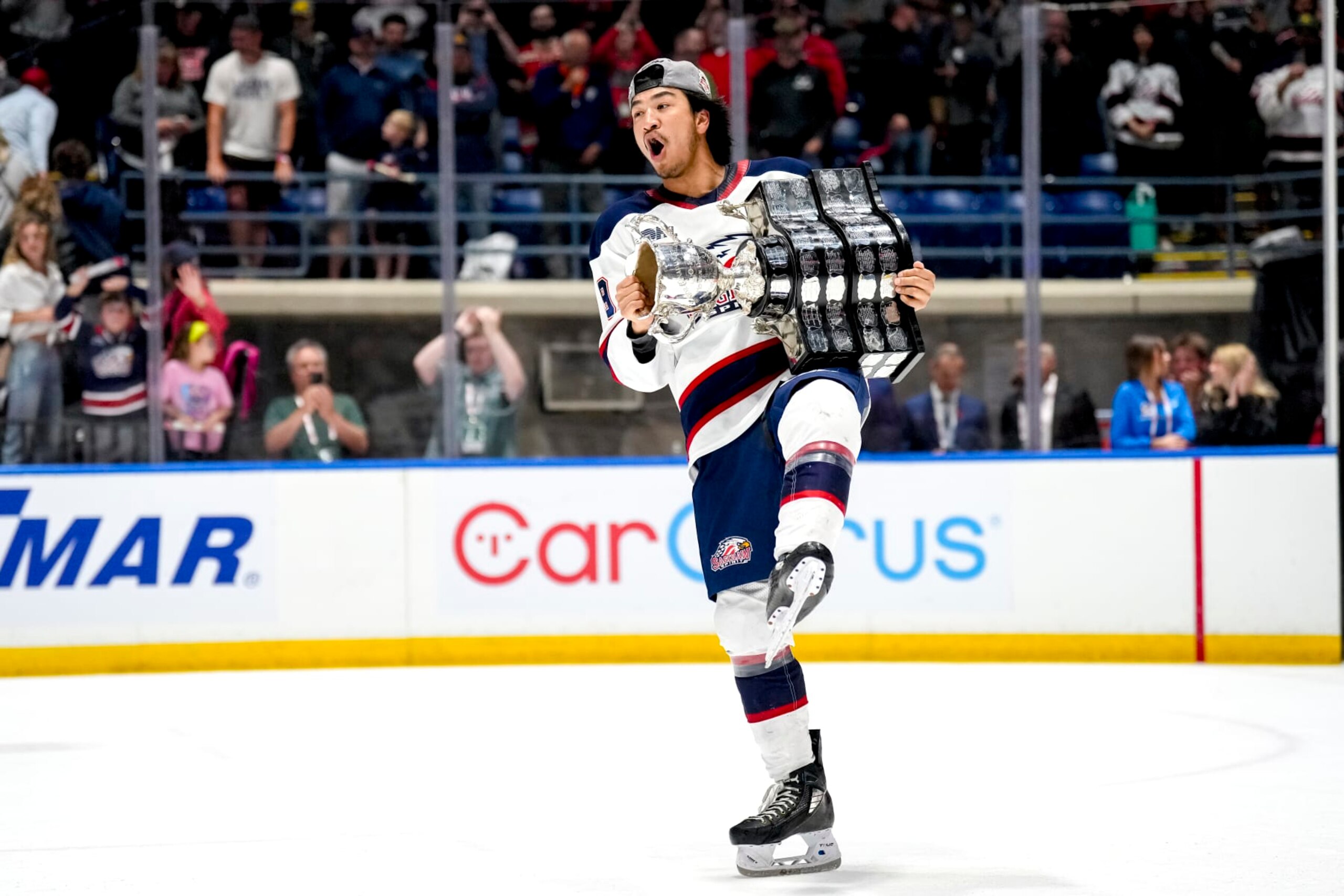 SAGINAW, MICHIGAN - JUNE 02: Zayne Parekh #19 of the Saginaw Spirit celebrates with the Memorial Cup after defeating the London Knights in the 2024 Memorial Cup Final at Dow Event Center on June 02, 2024 in Saginaw, Michigan. (Photo by Nic Antaya/Getty Images)