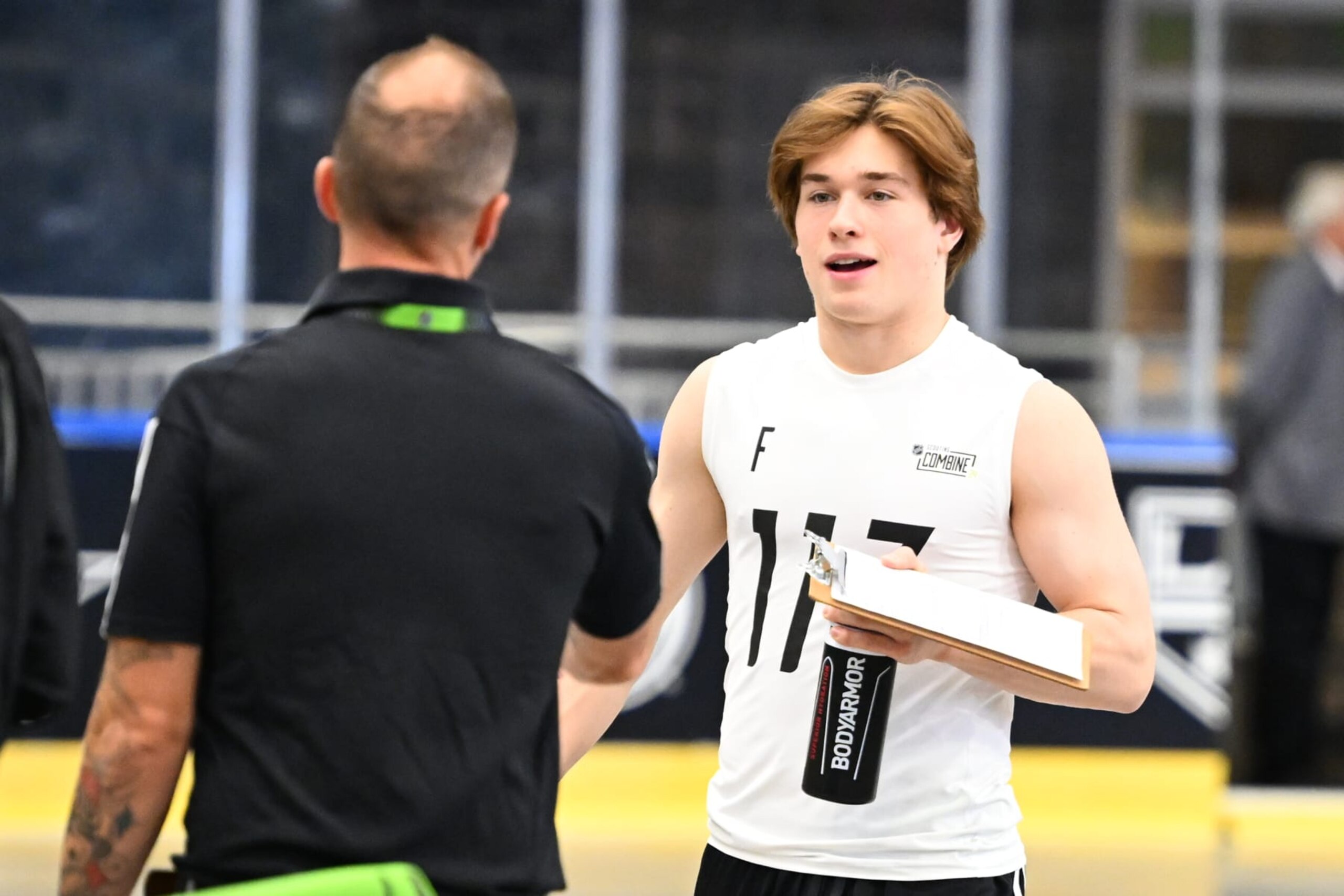 BUFFALO, NEW YORK - JUNE 10: Macklin Celebrini #117 is greeted by a testing assistant during the 2024 NHL Scouting Combine at LECOM Harborcenter on June 10, 2024 in Buffalo, New York. (Photo by Joe Hrycych/NHLI via Getty Images)