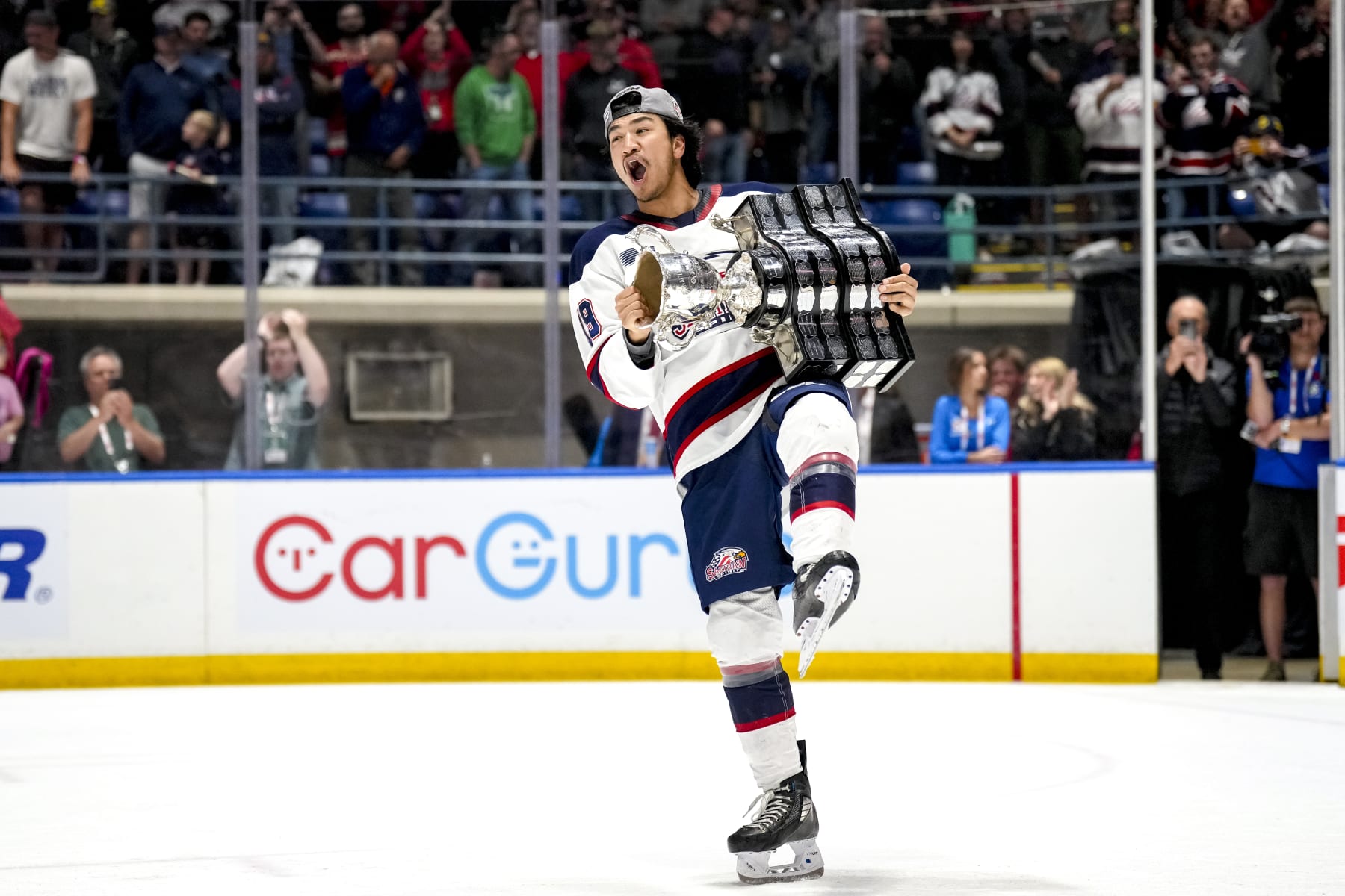 SAGINAW, MICHIGAN - JUNE 02: Zayne Parekh #19 of the Saginaw Spirit celebrates with the Memorial Cup after defeating the London Knights in the 2024 Memorial Cup Final at Dow Event Center on June 02, 2024 in Saginaw, Michigan. (Photo by Nic Antaya/Getty Images)