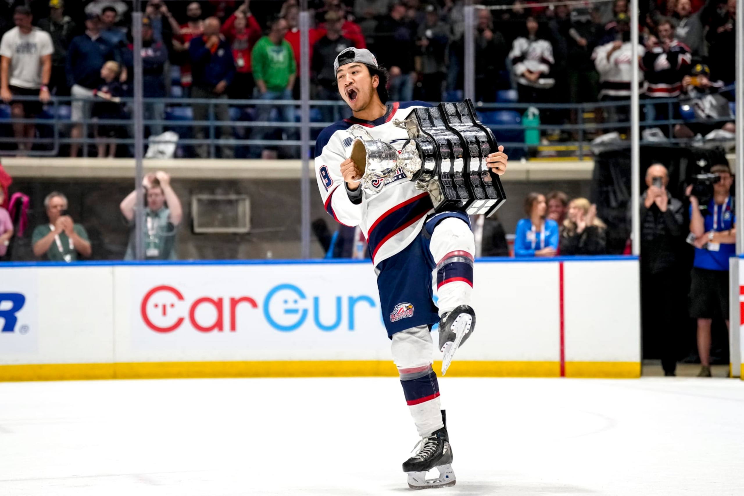 SAGINAW, MICHIGAN - JUNE 02: Zayne Parekh #19 of the Saginaw Spirit celebrates with the Memorial Cup after defeating the London Knights in the 2024 Memorial Cup Final at Dow Event Center on June 02, 2024 in Saginaw, Michigan. (Photo by Nic Antaya/Getty Images)