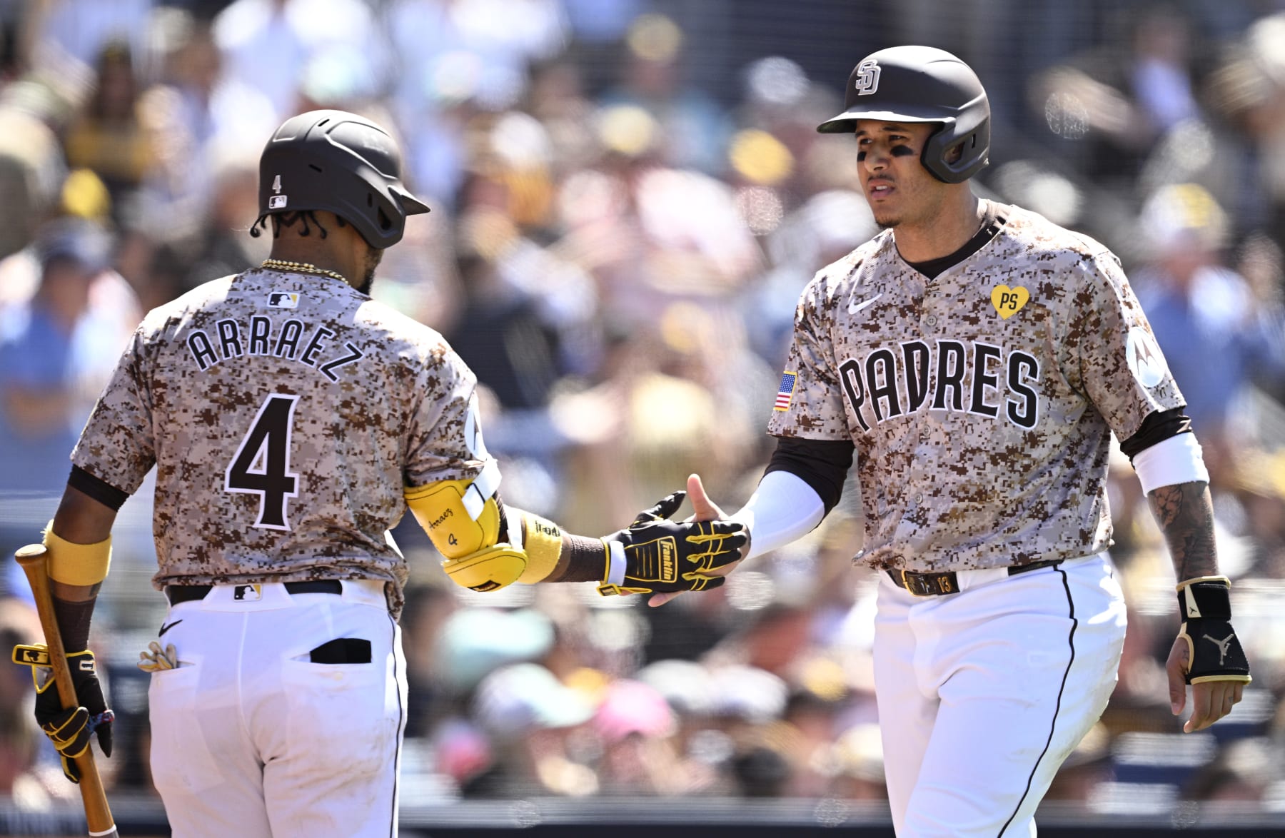 SAN DIEGO, CALIFORNIA - MAY 26: Manny Machado #13 of the San Diego Padres is congratulated by Luis Arraez #4 after scoring a run against the New York Yankees during the sixth inning at Petco Park on May 26, 2024 in San Diego, California. (Photo by Orlando Ramirez/Getty Images)