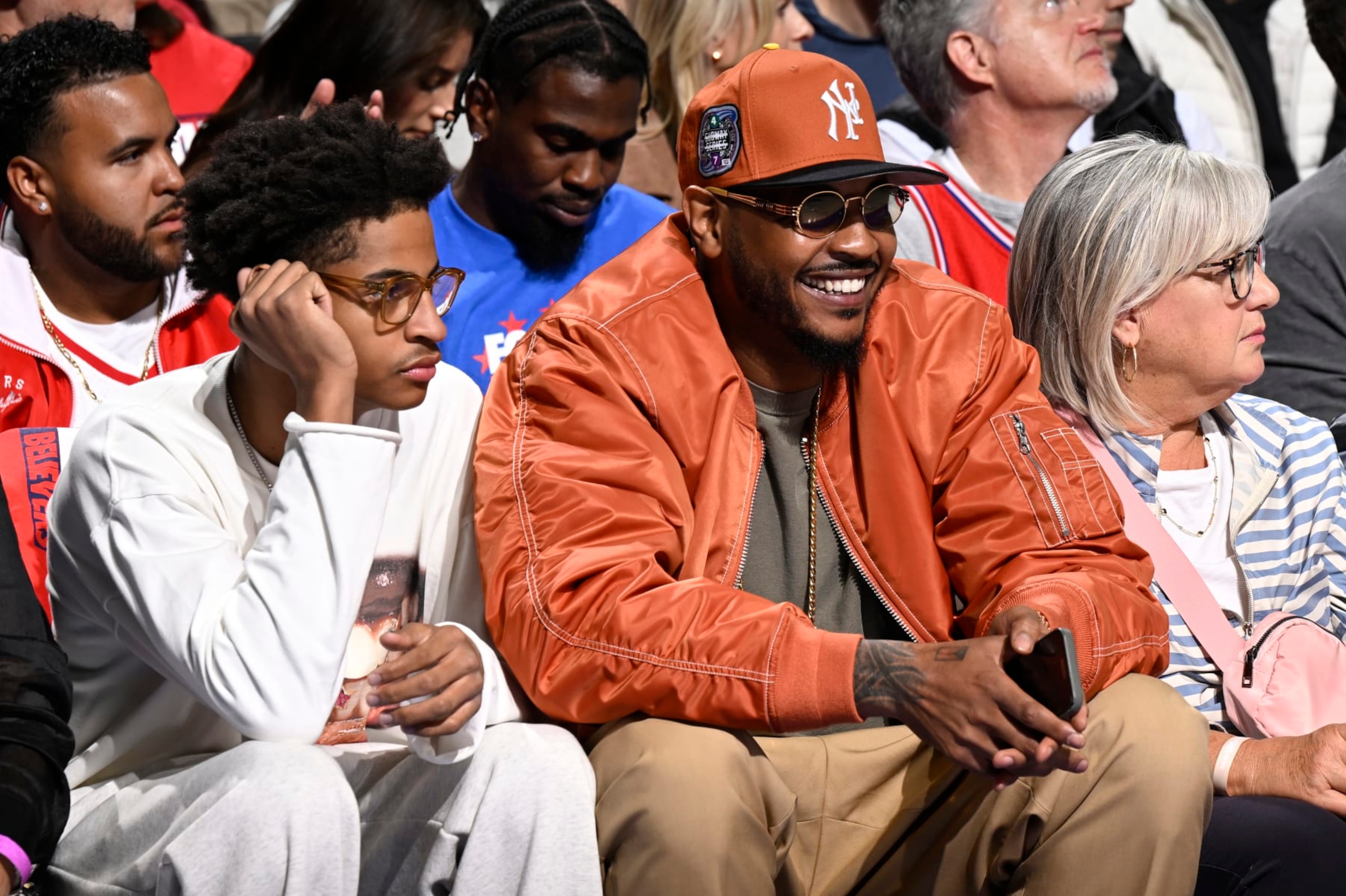 PHILADELPHIA, PA - APRIL 25: Carmelo Anthony and Kiyan Anthony attend the game between the New York Knicks and the Philadelphia 76ers during Round 1 Game 3 of the 2024 NBA Playoffs on April 25, 2024 at the Wells Fargo Center in Philadelphia, Pennsylvania NOTE TO USER: User expressly acknowledges and agrees that, by downloading and/or using this Photograph, user is consenting to the terms and conditions of the Getty Images License Agreement. Mandatory Copyright Notice: Copyright 2024 NBAE (Photo by David Dow/NBAE via Getty Images)