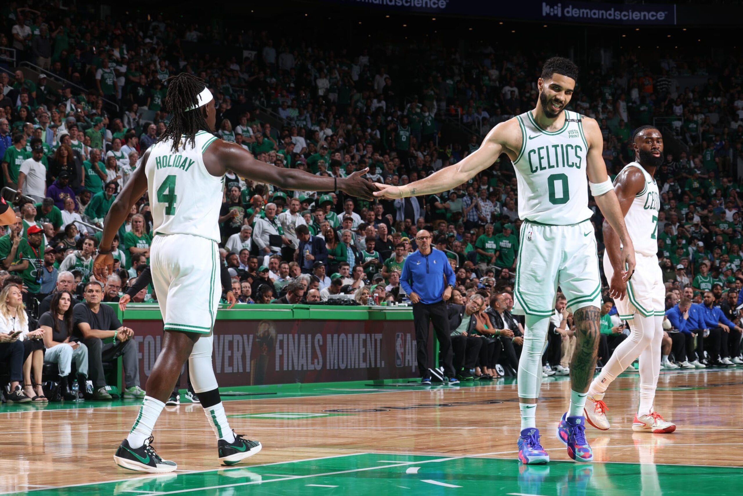 BOSTON, MA - JUNE 6: Jayson Tatum #0 high fives Jrue Holiday #4 of the Boston Celtics during the game against the Dallas Mavericks during Game 1 of the 2024 NBA Finals on June 6, 2024 at the TD Garden in Boston, Massachusetts. NOTE TO USER: User expressly acknowledges and agrees that, by downloading and or using this photograph, User is consenting to the terms and conditions of the Getty Images License Agreement. Mandatory Copyright Notice: Copyright 2024 NBAE  (Photo by Nathaniel S. Butler/NBAE via Getty Images)