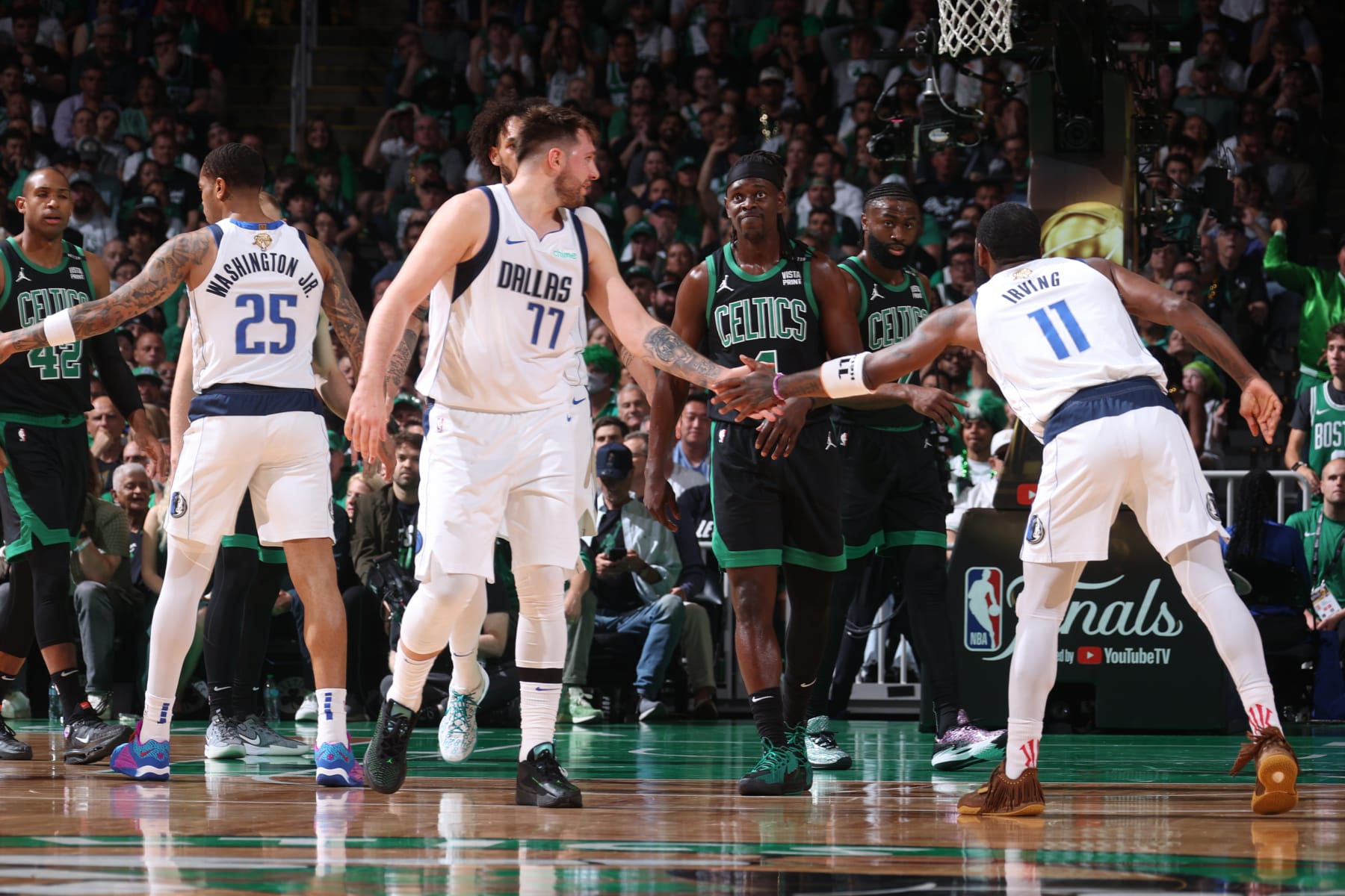 BOSTON, MA - JUNE 9: Luka Doncic #77 and Kyrie Irving #11 of the Dallas Mavericks high five during the game against the Boston Celtics during Game 1 of the 2024 NBA Finals on June 9, 2024 at the TD Garden in Boston, Massachusetts. NOTE TO USER: User expressly acknowledges and agrees that, by downloading and or using this photograph, User is consenting to the terms and conditions of the Getty Images License Agreement. Mandatory Copyright Notice: Copyright 2024 NBAE  (Photo by Nathaniel S. Butler/NBAE via Getty Images)