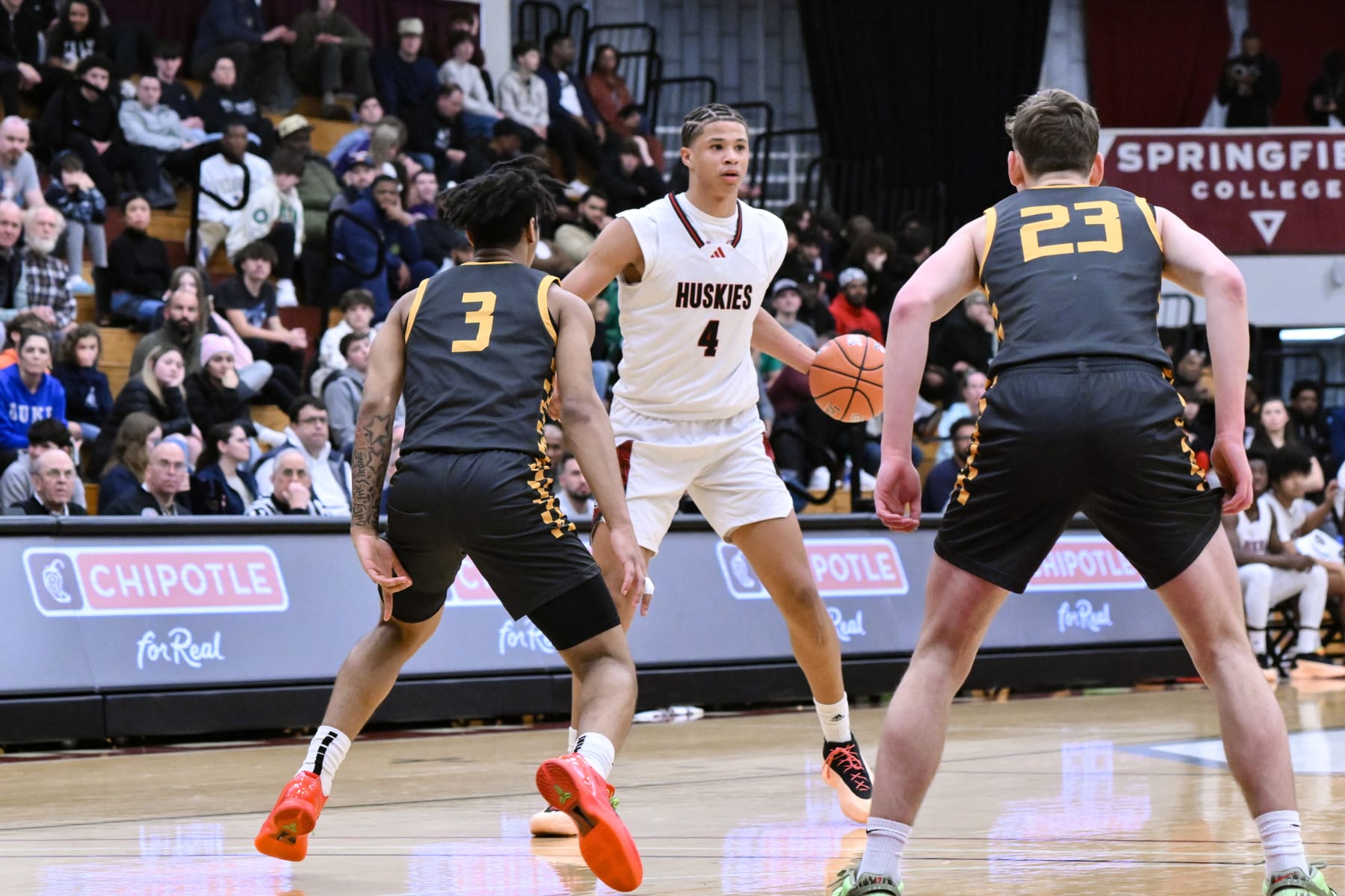 SPRINGFIELD, MA - JANUARY 13: Carter Bryant of Corona Centennial (4) sets the play as Milan Dean of Archbishop Wood HS (3) and Brady McAdams of Archbishop Wood HS (23) defend during the first half of the Spalding Hoophall Classic high school basketball game between Archbishop Wood and Corona Centennial  on January 13, 2024 at Blake Arena in Springfield, MA (Photo by John Jones/Icon Sportswire via Getty Images)