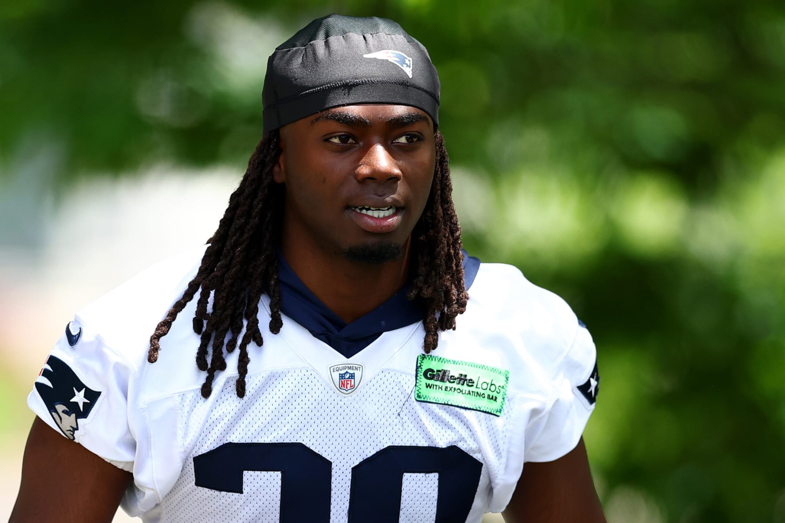 FOXBOROUGH, MASSACHUSETTS - MAY 29: Rhamondre Stevenson #38 of the New England Patriots walks to the field during the New England Patriots OTA Offseason Workout on May 29, 2024 in Foxborough, Massachusetts.  (Photo by Maddie Meyer/Getty Images)