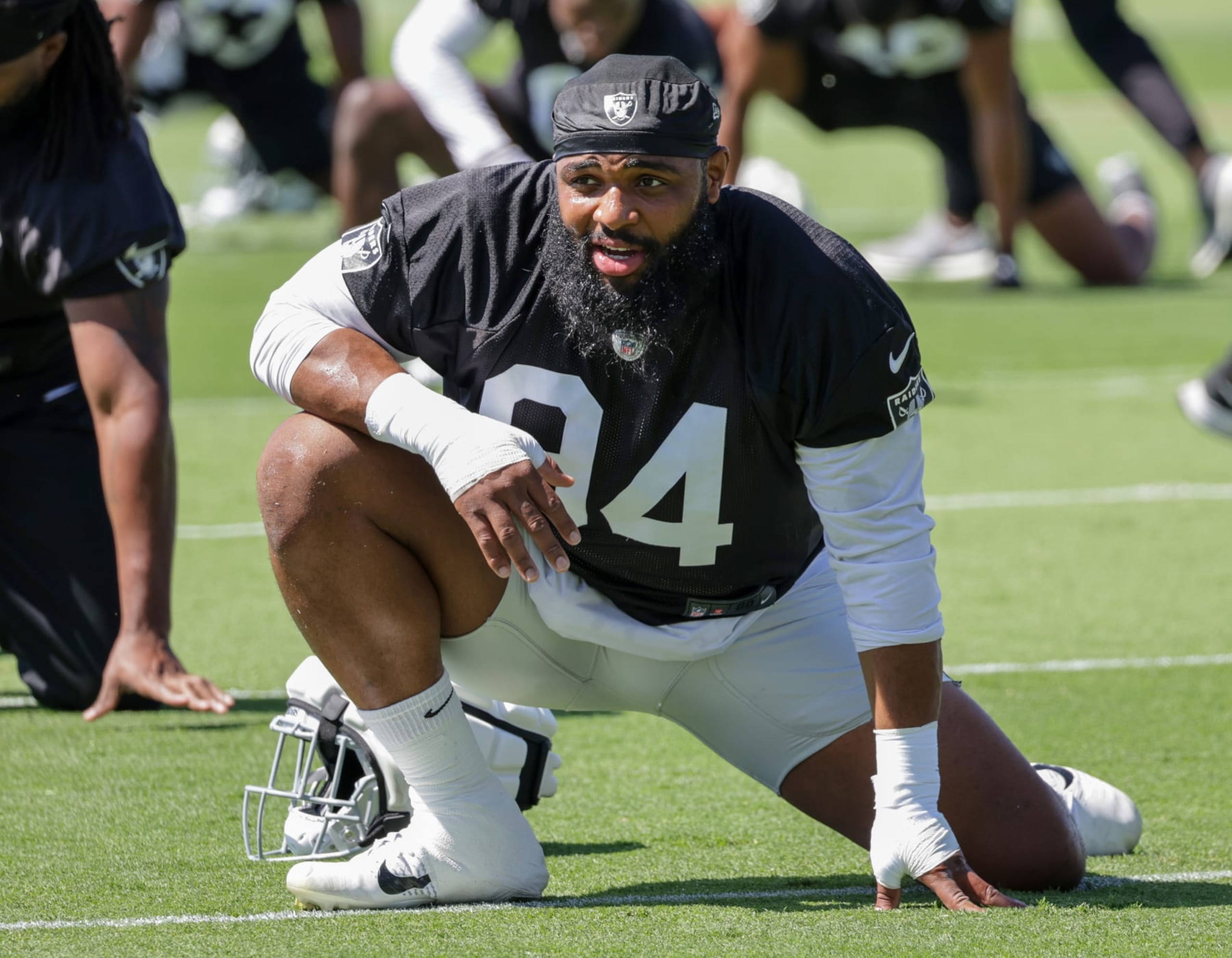HENDERSON, NEVADA - MAY 29: Defensive tackle Christian Wilkins #94 of the Las Vegas Raiders stretches during an OTA offseason workout at the Las Vegas Raiders Headquarters/Intermountain Healthcare Performance Center on May 29, 2024 in Henderson, Nevada. (Photo by Ethan Miller/Getty Images)