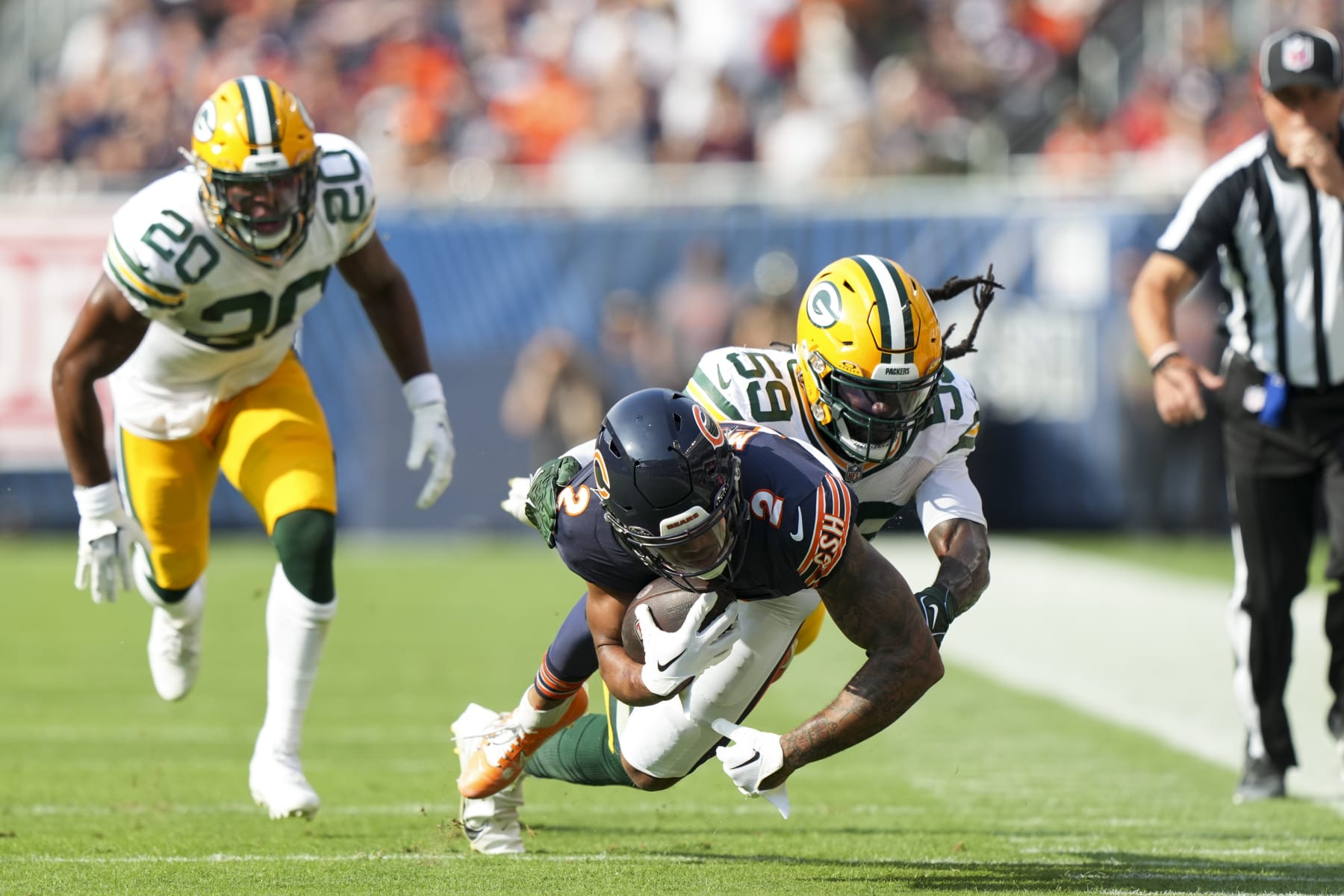 CHICAGO, IL - SEPTEMBER 10: Linebacker De'Vondre Campbell #59 of the Green Bay Packers tackles DJ Moore #2 of the Chicago Bears during an NFL football game against the Green Bay Packers at Soldier Field on September 10, 2023 in Chicago, Illinois. (Photo by Todd Rosenberg/Getty Images)