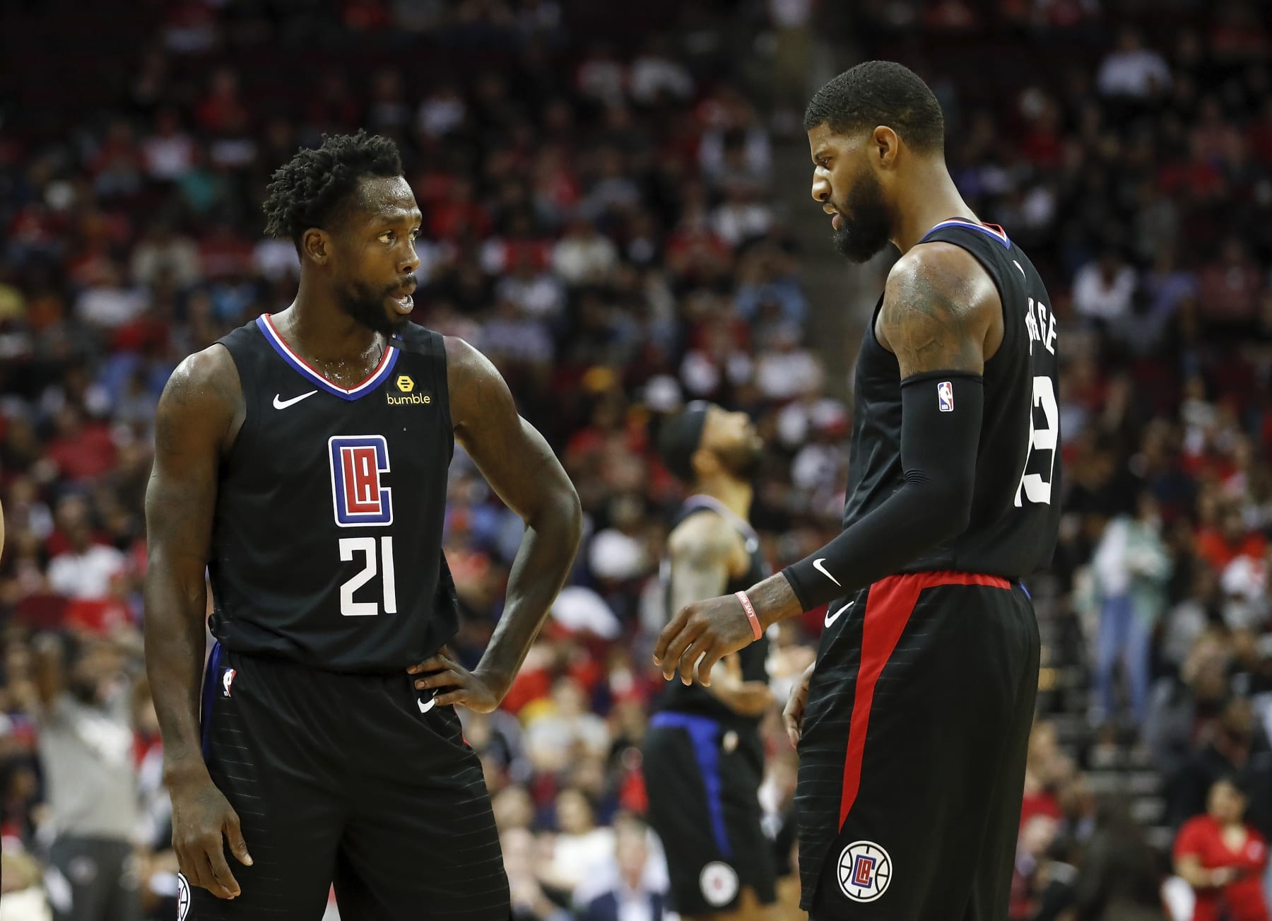 HOUSTON, TEXAS - MARCH 05: Patrick Beverley #21 of the LA Clippers talks with Paul George #13 in the first half against the Houston Rockets at Toyota Center on March 05, 2020 in Houston, Texas.  NOTE TO USER: User expressly acknowledges and agrees that, by downloading and or using this photograph, User is consenting to the terms and conditions of the Getty Images License Agreement. (Photo by Tim Warner/Getty Images)