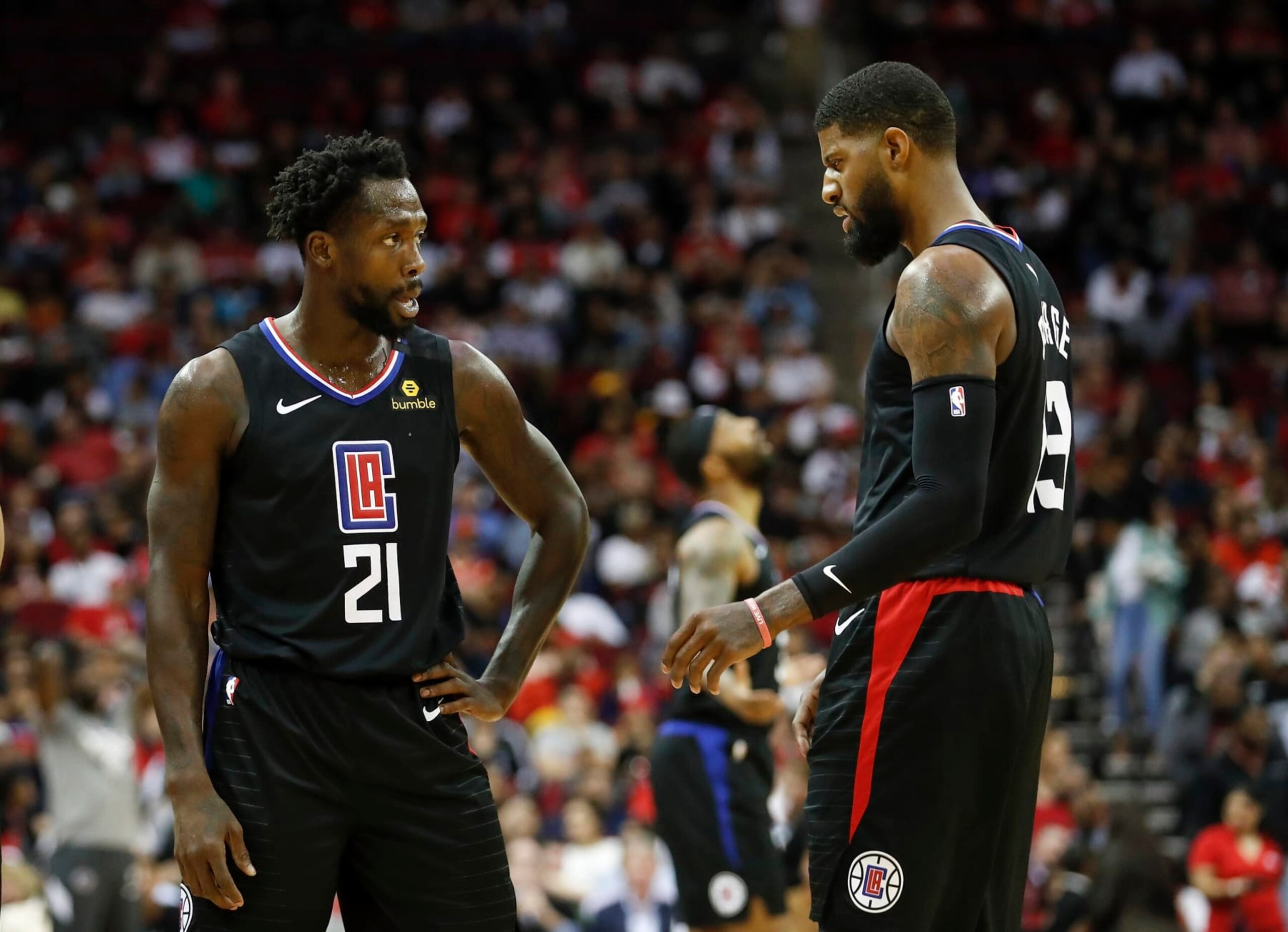 HOUSTON, TEXAS - MARCH 05: Patrick Beverley #21 of the LA Clippers talks with Paul George #13 in the first half against the Houston Rockets at Toyota Center on March 05, 2020 in Houston, Texas.  NOTE TO USER: User expressly acknowledges and agrees that, by downloading and or using this photograph, User is consenting to the terms and conditions of the Getty Images License Agreement. (Photo by Tim Warner/Getty Images)