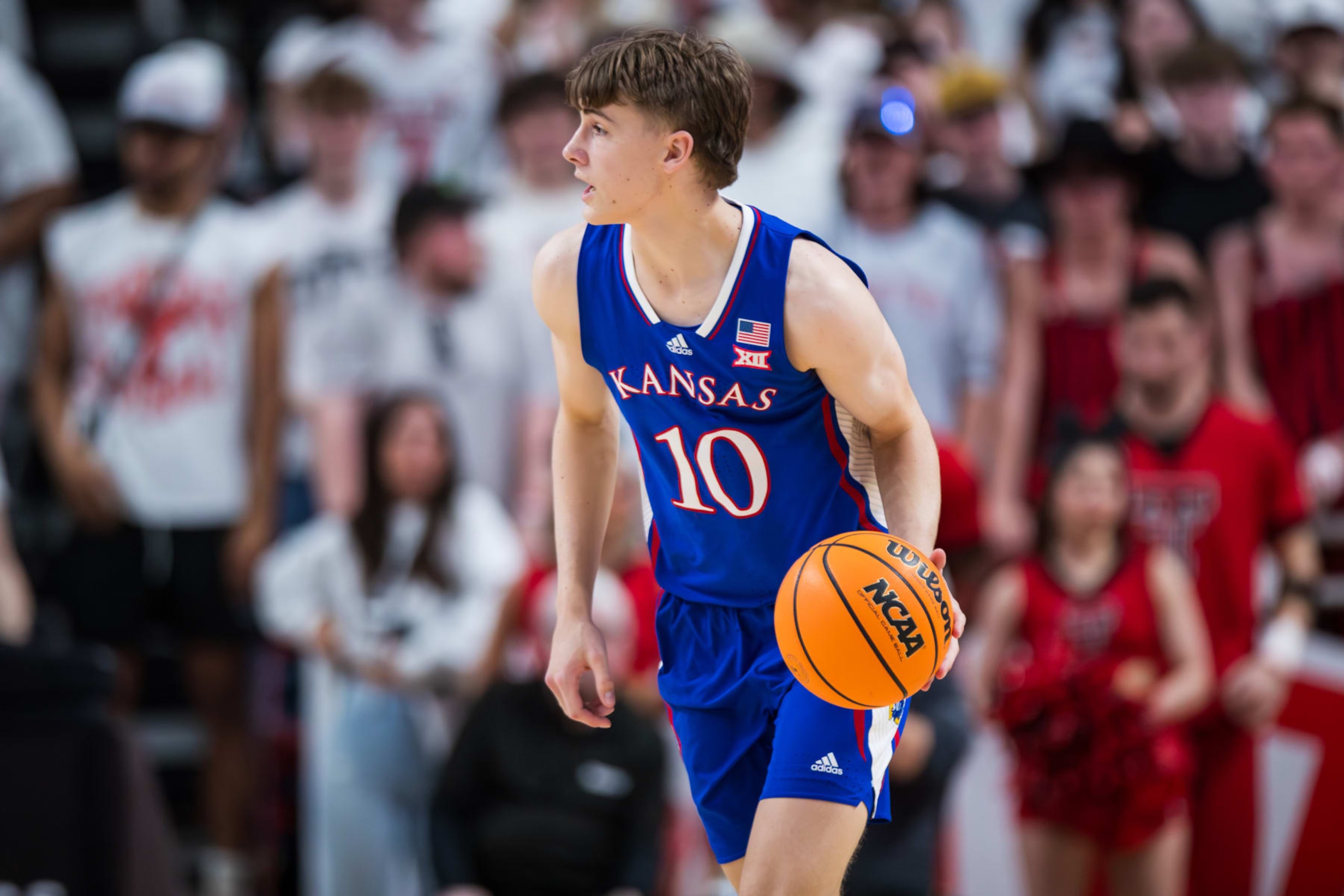 LUBBOCK, TEXAS - FEBRUARY 12: Johnny Furphy #10 of the Kansas Jayhawks handles the ball during the first half of the game against the Texas Tech Red Raiders at United Supermarkets Arena on February 12, 2024 in Lubbock, Texas. (Photo by John E. Moore III/Getty Images)