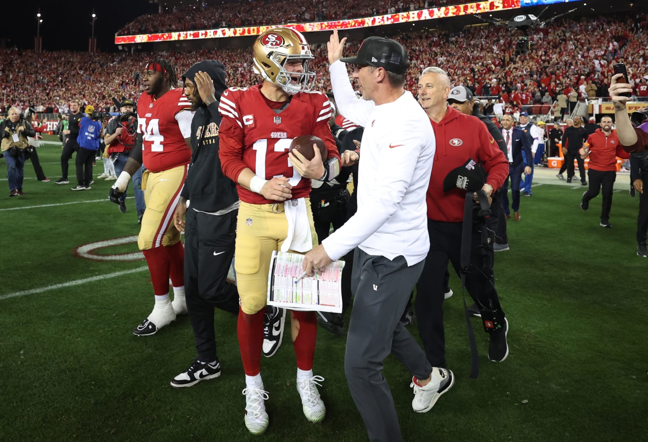 SANTA CLARA, CALIFORNIA - JANUARY 28: Brock Purdy #13 of the San Francisco 49ers celebrates with Head coach Kyle Shanahan  after defeating the Detroit Lions 34-31 in the NFC Championship Game at Levi's Stadium on January 28, 2024 in Santa Clara, California. (Photo by Ezra Shaw/Getty Images)