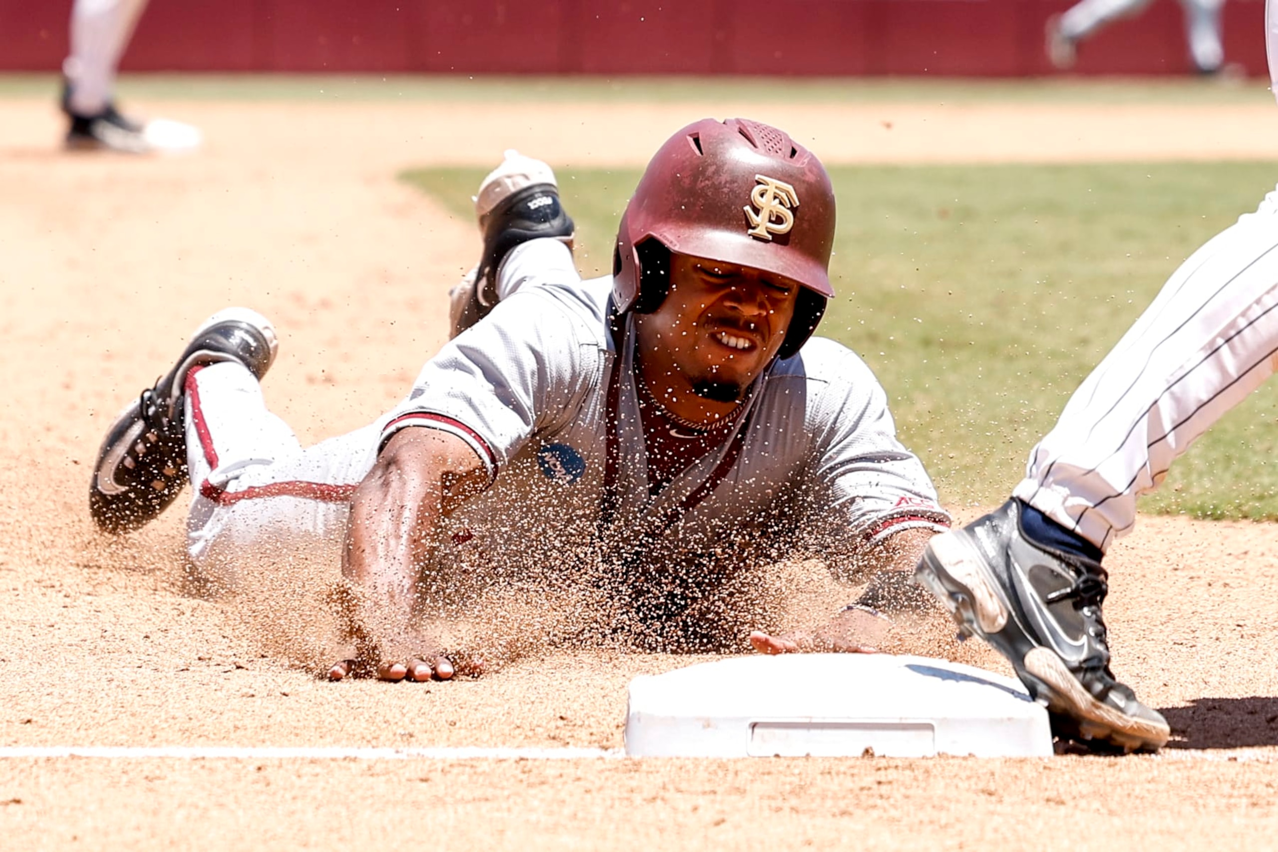 TALLAHASSEE, FL - JUNE 08: Outfielder Jordan Williams #12 of the Florida State Seminoles slides into third base during game 2 against the UConn Huskies in the 2024 NCAA Baseball Super Regional on Mike Martin Field at Dick Howser Stadium on June 8, 2024 in Tallahassee, Florida. The Seminoles defeated the UConn Huskies 10-8 in 12 innings to advance to the College World Series for the 24th time in the program history. (Photo by Don Juan Moore/Getty Images) TALLAHASSEE, FL - JUNE 08: Outfielder Jordan Williams #12 of the Florida State Seminoles slides into third base during game 2 against the UConn Huskies in the 2024 NCAA Baseball Super Regional on Mike Martin Field at Dick Howser Stadium on June 8, 2024 in Tallahassee, Florida. The Seminoles defeated the UConn Huskies 10-8 in 12 innings to advance to the College World Series for the 24th time in the program history. (Photo by Don Juan Moore/Getty Images)