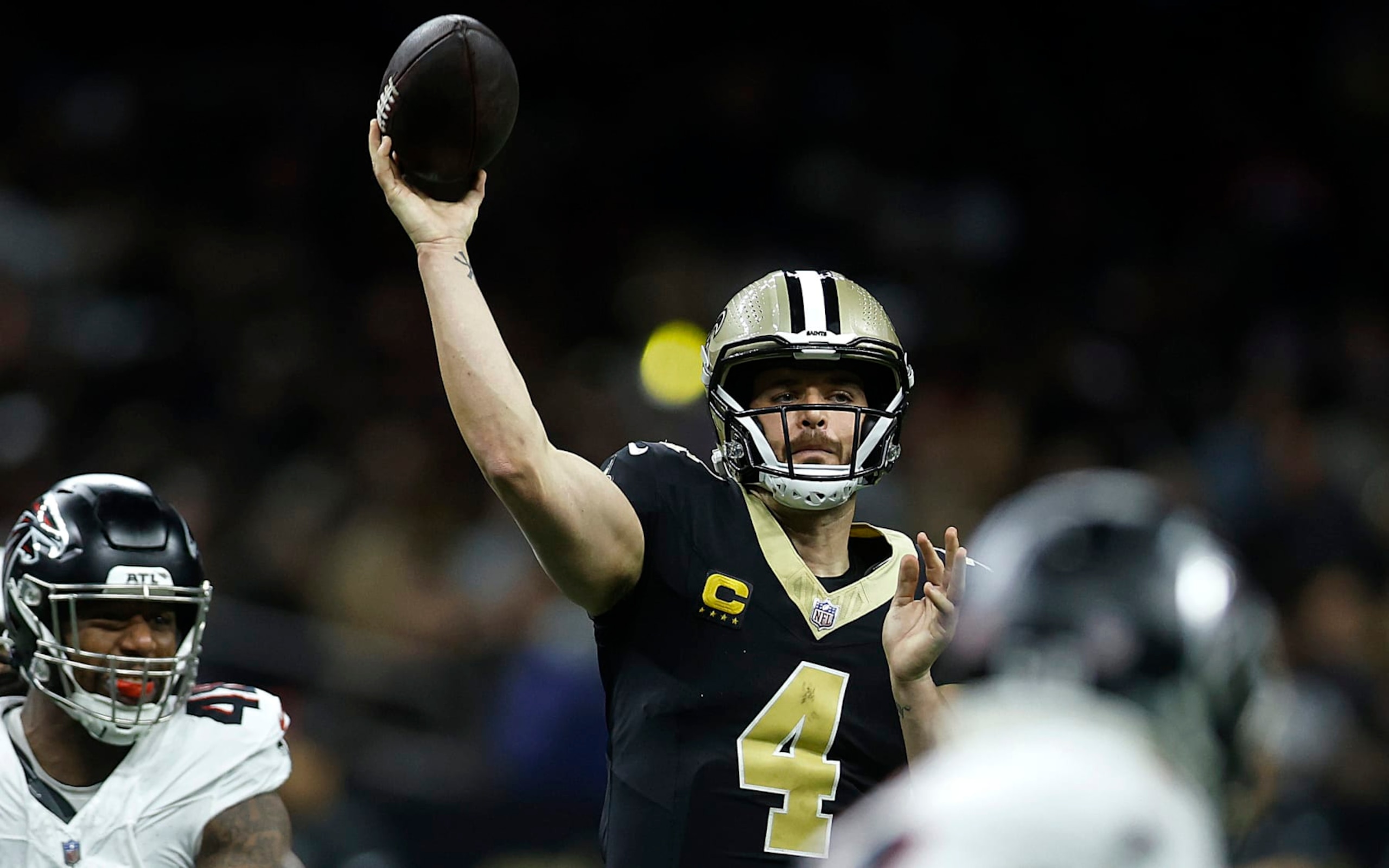 NEW ORLEANS, LOUISIANA - JANUARY 07: Derek Carr #4 of the New Orleans Saints throws the ball under pressure in the first half during a game against the Atlanta Falcons at Caesars Superdome on January 07, 2024 in New Orleans, Louisiana. (Photo by Chris Graythen/Getty Images)
