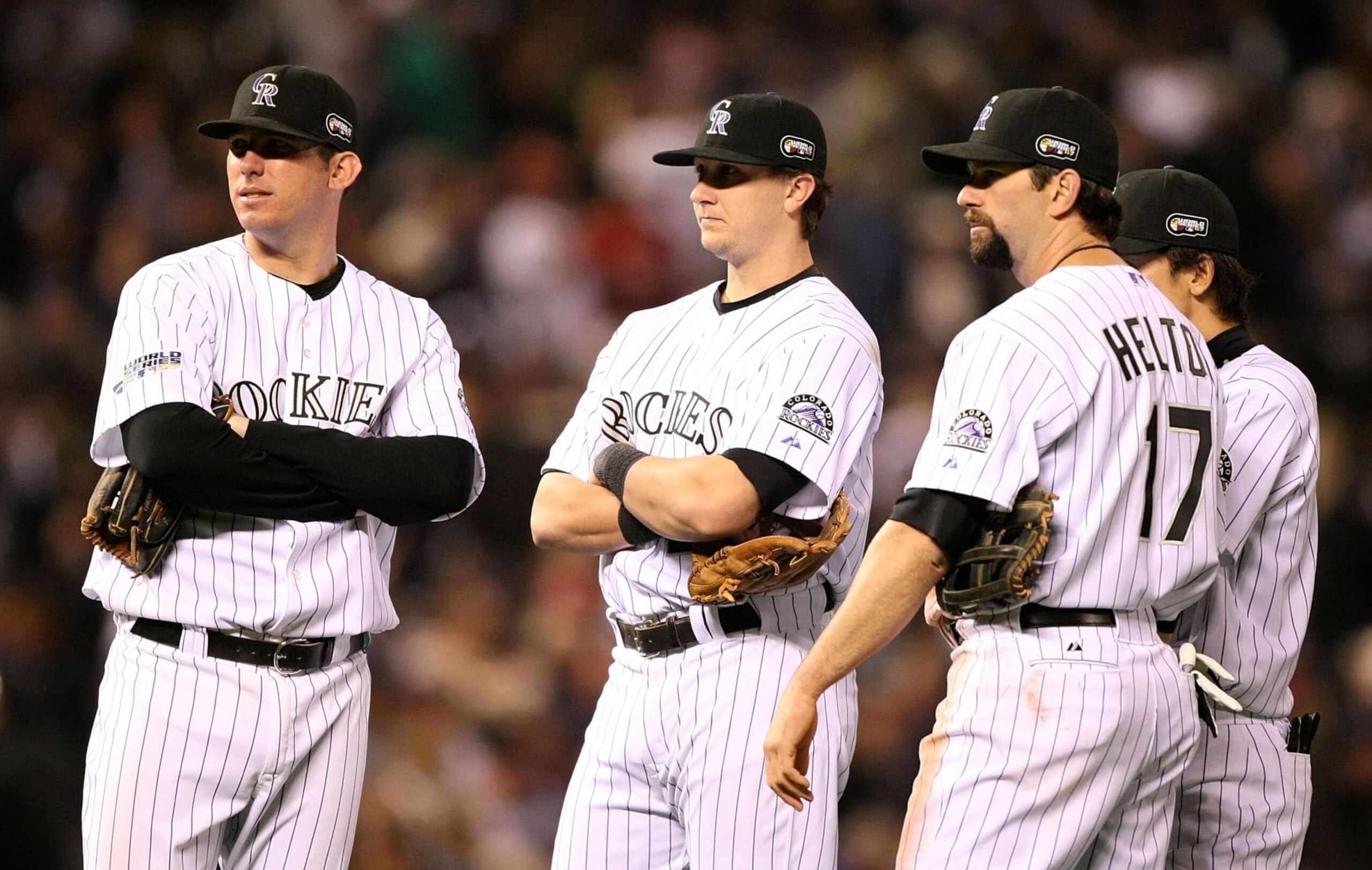 DENVER - OCTOBER 28:  Garrett Atkins #27, Kazuo Matsui #7, Todd Helton #17 and Troy Tulowitzki #2 of the Colorado Rockies looks on during a pitching change against the Boston Red Sox during Game Four of the 2007 Major League Baseball World Series at Coors Field on October 28, 2007 in Denver, Colorado.  (Photo by Jed Jacobsohn/Getty Images)