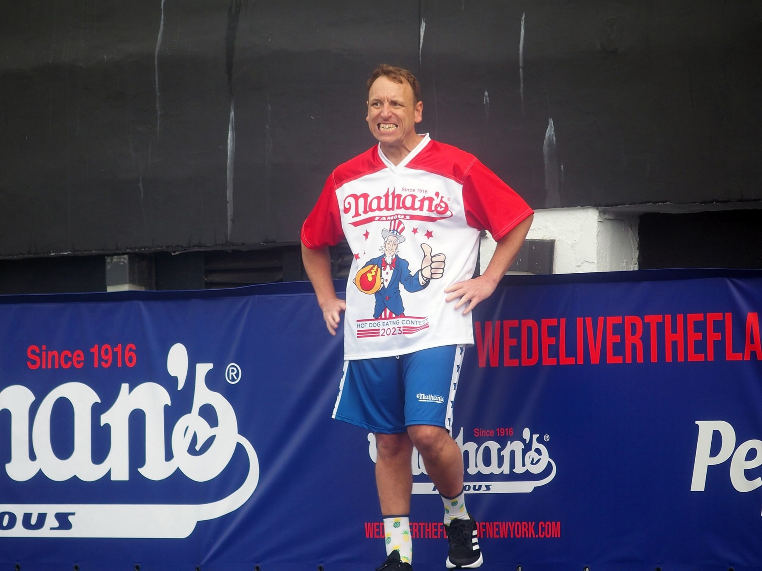 NEW YORK, NY - JULY 04:  Defending champion Joey Chestnut competes in the 2023 Nathan's Famous International Hot Dog Eating Contest at Coney Island on July 4, 2023 in New York City.  (Photo by Bobby Bank/Getty Images)