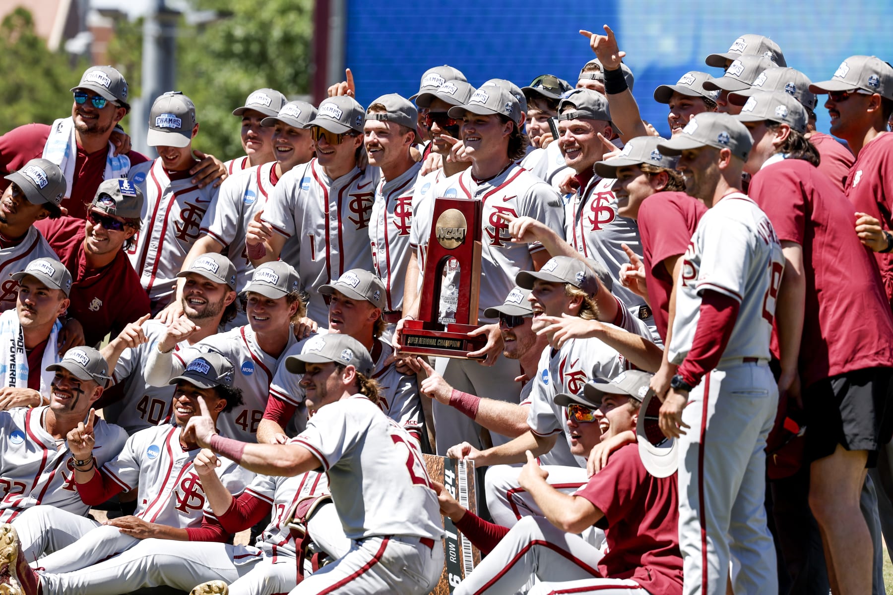 TALLAHASSEE, FL - JUNE 08: The entire Florida State Seminoles Baseball Team take a photo with the NCAA Baseball 2024 Super Regionals Trophy after game 2 against the UConn Huskies on Mike Martin Field at Dick Howser Stadium on June 8, 2024 in Tallahassee, Florida. The Seminoles defeated the UConn Huskies 10-8 in 12 innings to advance to the College World Series for the 24th time in the program history. (Photo by Don Juan Moore/Getty Images)