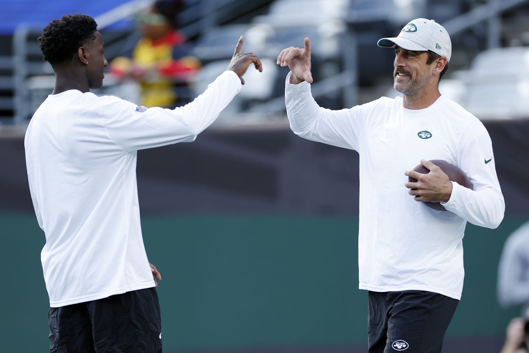 EAST RUTHERFORD, NEW JERSEY - AUGUST 19: Sauce Gardner #1 (L) talks with Aaron Rodgers #8 of the New York Jets during warmups before the first half of a preseason game against the Tampa Bay Buccaneers at MetLife Stadium on August 19, 2023 in East Rutherford, New Jersey. (Photo by Sarah Stier/Getty Images)
