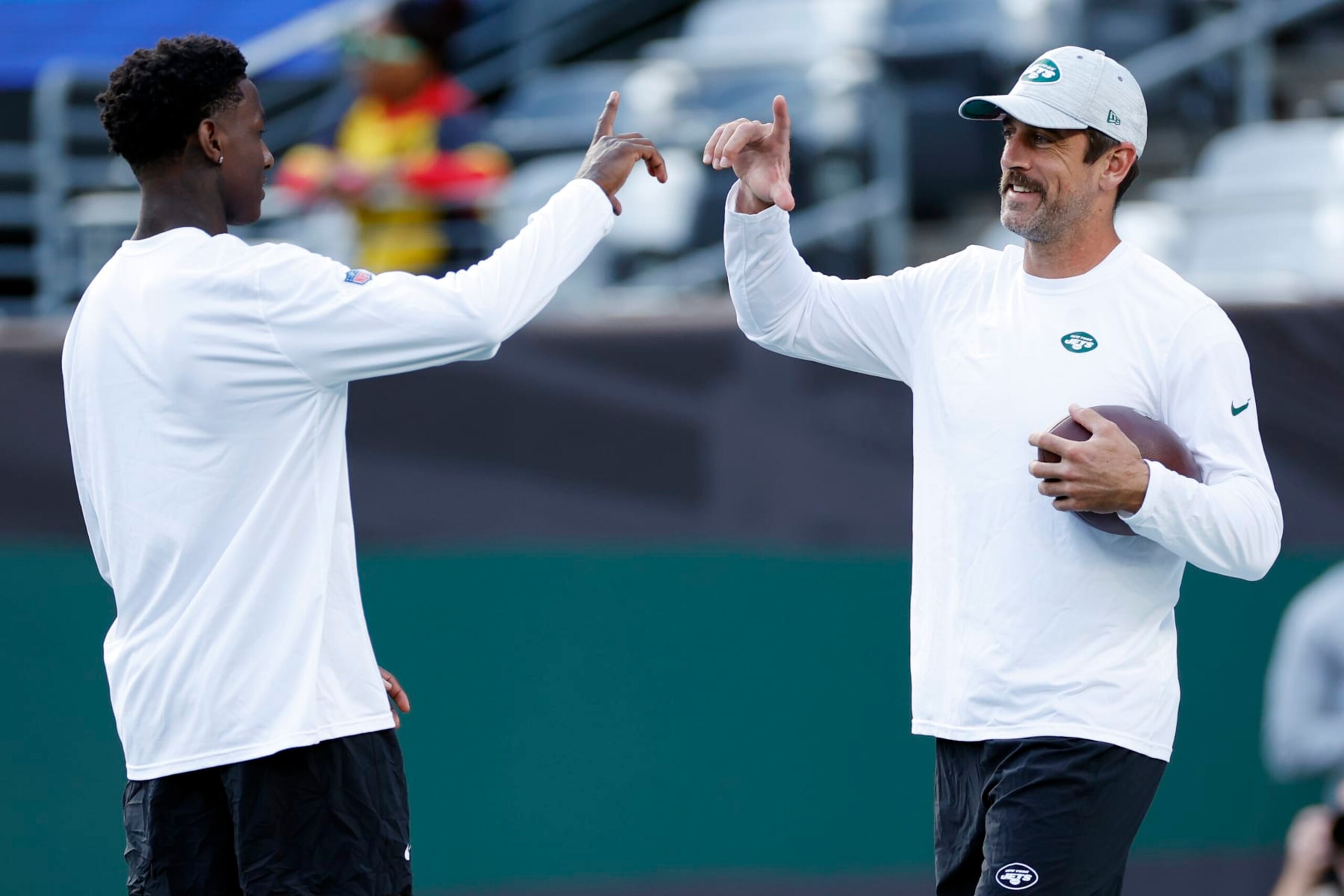 EAST RUTHERFORD, NEW JERSEY - AUGUST 19: Sauce Gardner #1 (L) talks with Aaron Rodgers #8 of the New York Jets during warmups before the first half of a preseason game against the Tampa Bay Buccaneers at MetLife Stadium on August 19, 2023 in East Rutherford, New Jersey. (Photo by Sarah Stier/Getty Images)