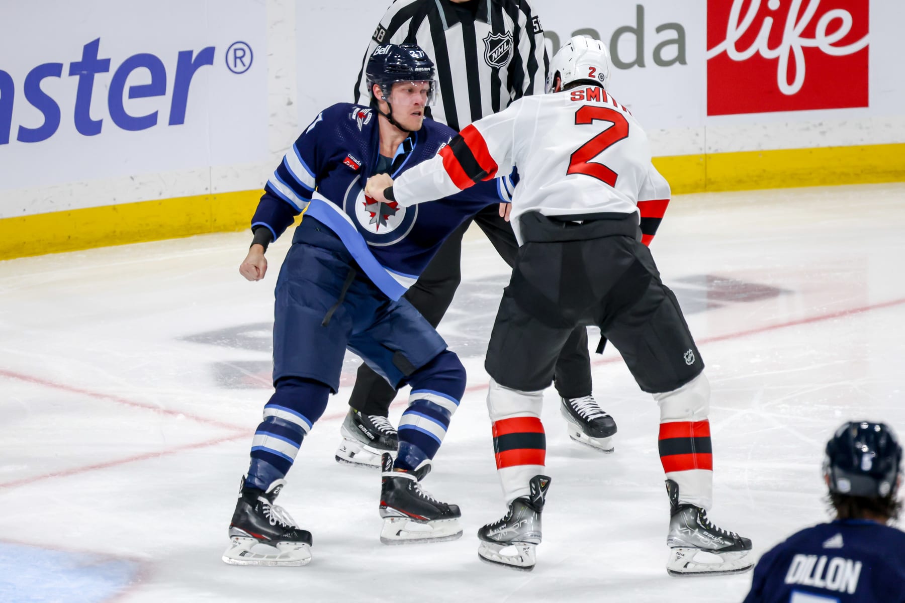 WINNIPEG, CANADA - NOVEMBER 14: Nikolaj Ehlers #27 of the Winnipeg Jets and Brendan Smith #2 of the New Jersey Devils get tangled up in a third period tussle at the Canada Life Centre on November 14, 2023 in Winnipeg, Manitoba, Canada. (Photo by Jonathan Kozub/NHLI via Getty Images)