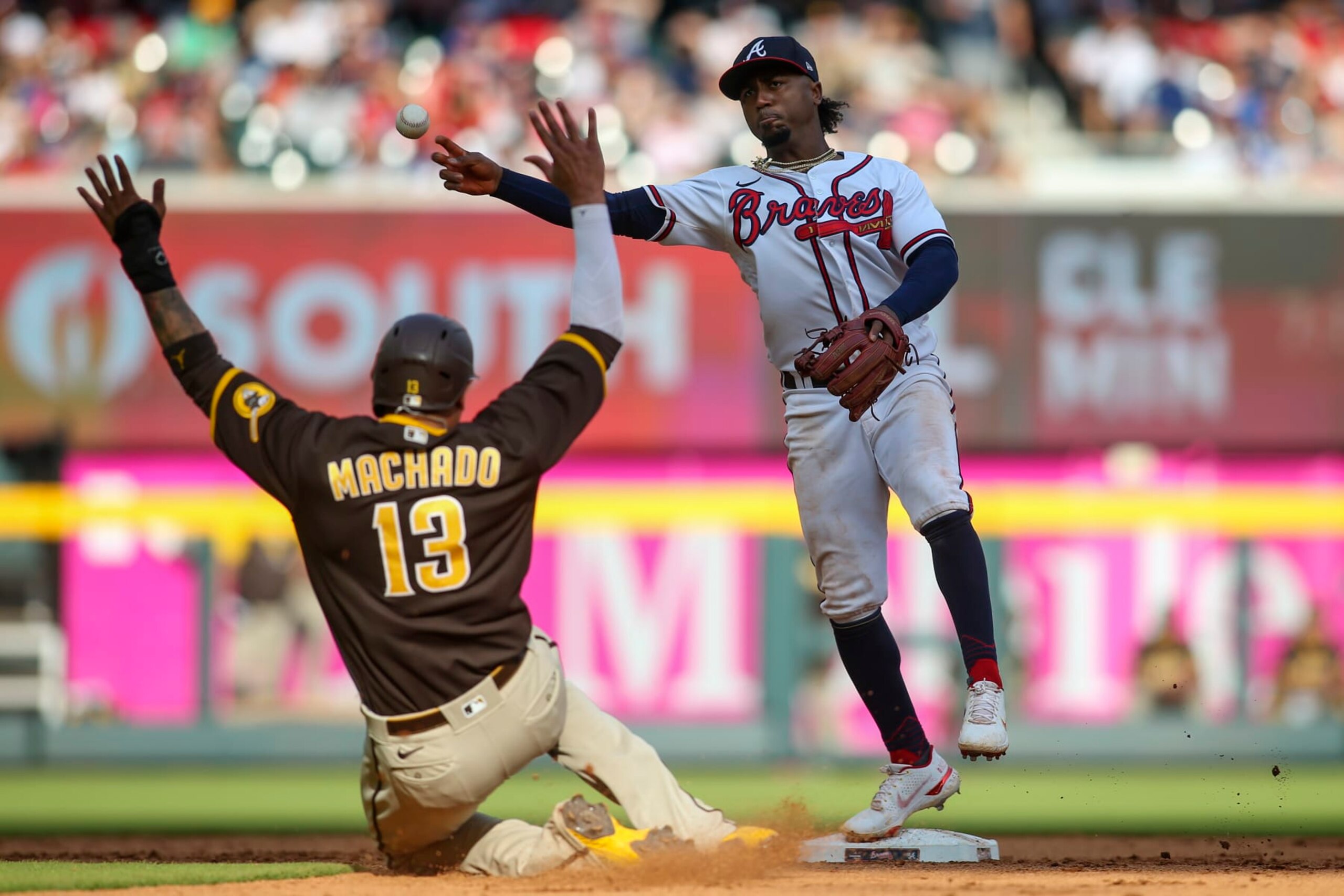 ATLANTA, GA - MAY 14: Ozzie Albies #1 of the Atlanta Braves attempts to turn a double play over Manny Machado #13 of the San Diego Padres in the eighth inning of a game at Truist Park on May 14, 2022 in Atlanta, Georgia. (Photo by Brett Davis/Getty Images) ATLANTA, GA - MAY 14: Ozzie Albies #1 of the Atlanta Braves attempts to turn a double play over Manny Machado #13 of the San Diego Padres in the eighth inning of a game at Truist Park on May 14, 2022 in Atlanta, Georgia. (Photo by Brett Davis/Getty Images)