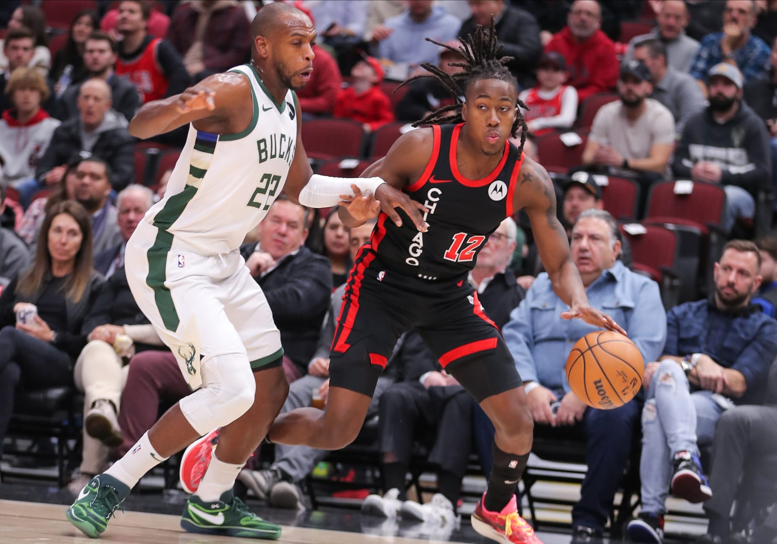 CHICAGO, IL - NOVEMBER 30: Ayo Dosunmu #12 of the Chicago Bulls drives to the basket past Khris Middleton #22 of the Milwaukee Bucks during the first half at the United Center on November 30, 2023 in Chicago, Illinois. (Photo by Melissa Tamez/Icon Sportswire via Getty Images)