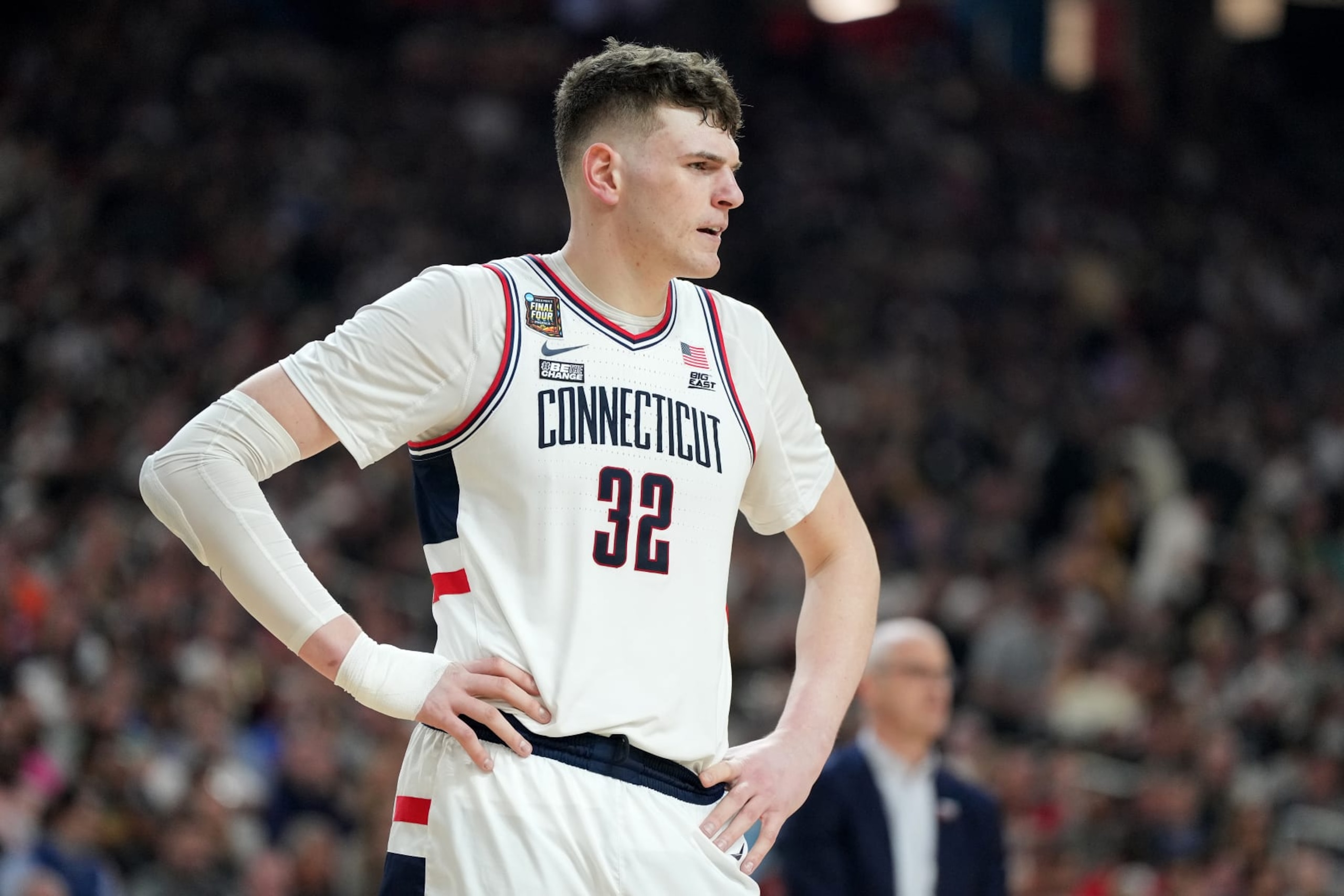 GLENDALE, ARIZONA - APRIL 06: Donovan Clingan #32 of The Connecticut Huskies looks on during the NCAA Mens Basketball Tournament Final Four semifinal game against the Alabama Crimson Tide at State Farm Stadium on April 06, 2024 in Glendale, Arizona. (Photo by Mitchell Layton/Getty Images)