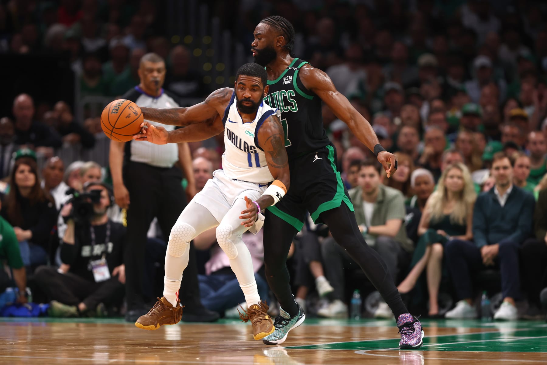 BOSTON, MASSACHUSETTS - JUNE 09: Kyrie Irving #11 of the Dallas Mavericks dribbles the ball against Jaylen Brown #7 of the Boston Celtics during the first quarter in Game Two of the 2024 NBA Finals at TD Garden on June 09, 2024 in Boston, Massachusetts. NOTE TO USER: User expressly acknowledges and agrees that, by downloading and or using this photograph, User is consenting to the terms and conditions of the Getty Images License Agreement. (Photo by Maddie Meyer/Getty Images)