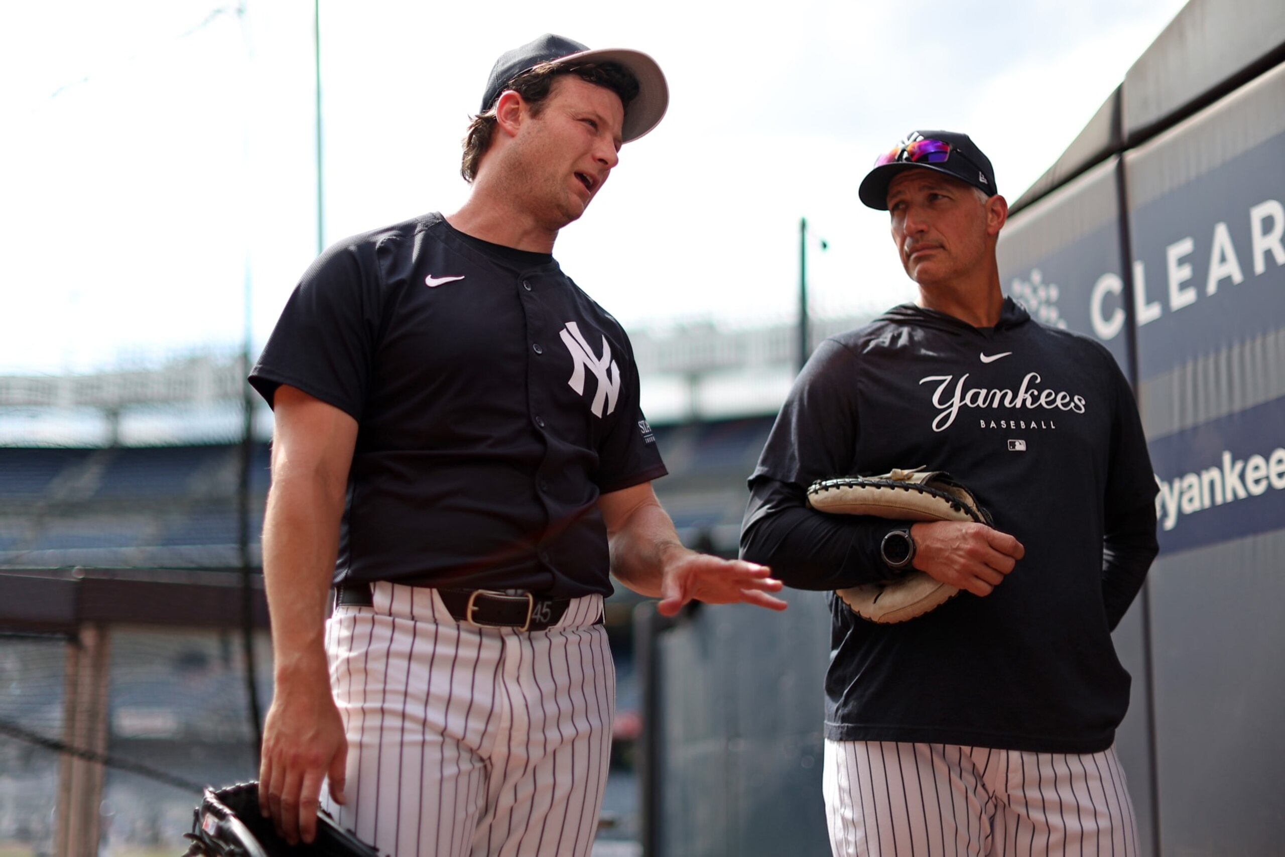 NEW YORK, NY - JUNE 7: Gerrit Cole #45 of the New York Yankees talks with Andy Pettitte before the game against the Los Angeles Dodgers at Yankee Stadium on June 7, 2024, in New York, New York. (Photo by New York Yankees/Getty Images)