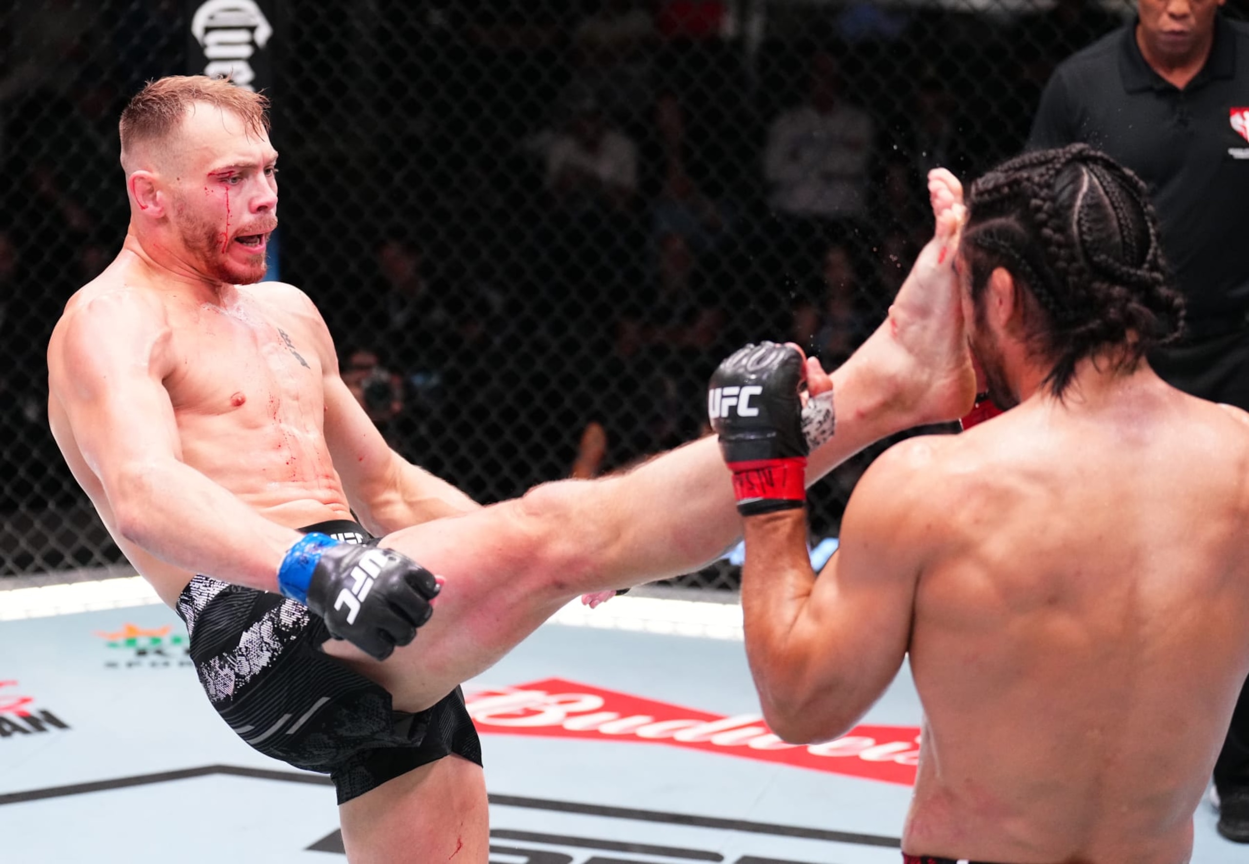 LAS VEGAS, NEVADA - JUNE 15: (L-R) Adam Fugitt kicks Josh Quinlan in a welterweight fight during the UFC Fight Night event at UFC APEX on June 15, 2024 in Las Vegas, Nevada.  (Photo by Chris Unger/Zuffa LLC via Getty Images)