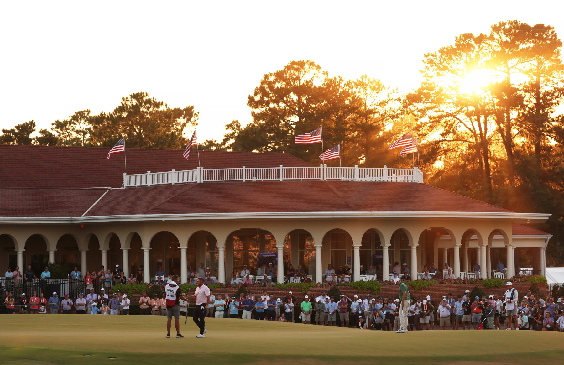 PINEHURST, NORTH CAROLINA - JUNE 15: Bryson DeChambeau of the United States shakes hands with his caddie Gregory Bodine on the 18th hole after finishing the third round of the 124th U.S. Open at Pinehurst Resort on June 15, 2024 in Pinehurst, North Carolina. (Photo by Gregory Shamus/Getty Images)