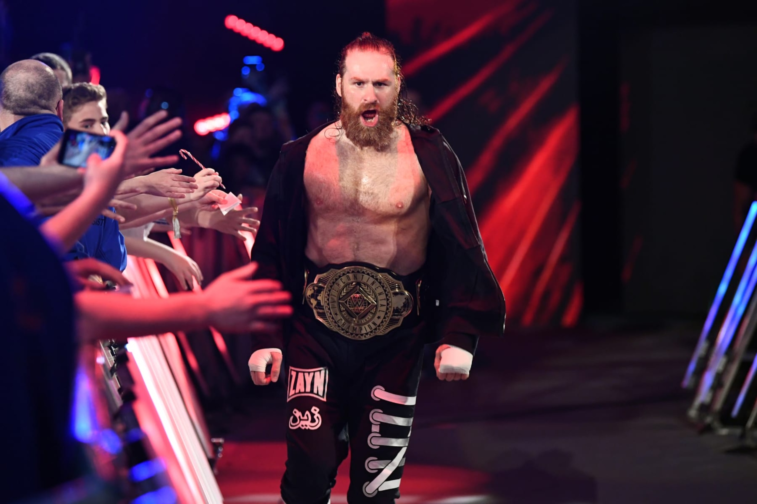 GLASGOW, SCOTLAND - JUNE 15: WWE Intercontinental champion  Sami Zayn makes his entrance for his title match against Chad Gable (not pictured) during WWE's Clash at the Castle, Premium Live Event at The OVO Hydro on June 15, 2024 in Glasgow, Scotland.  (Photo by WWE/Getty Images)