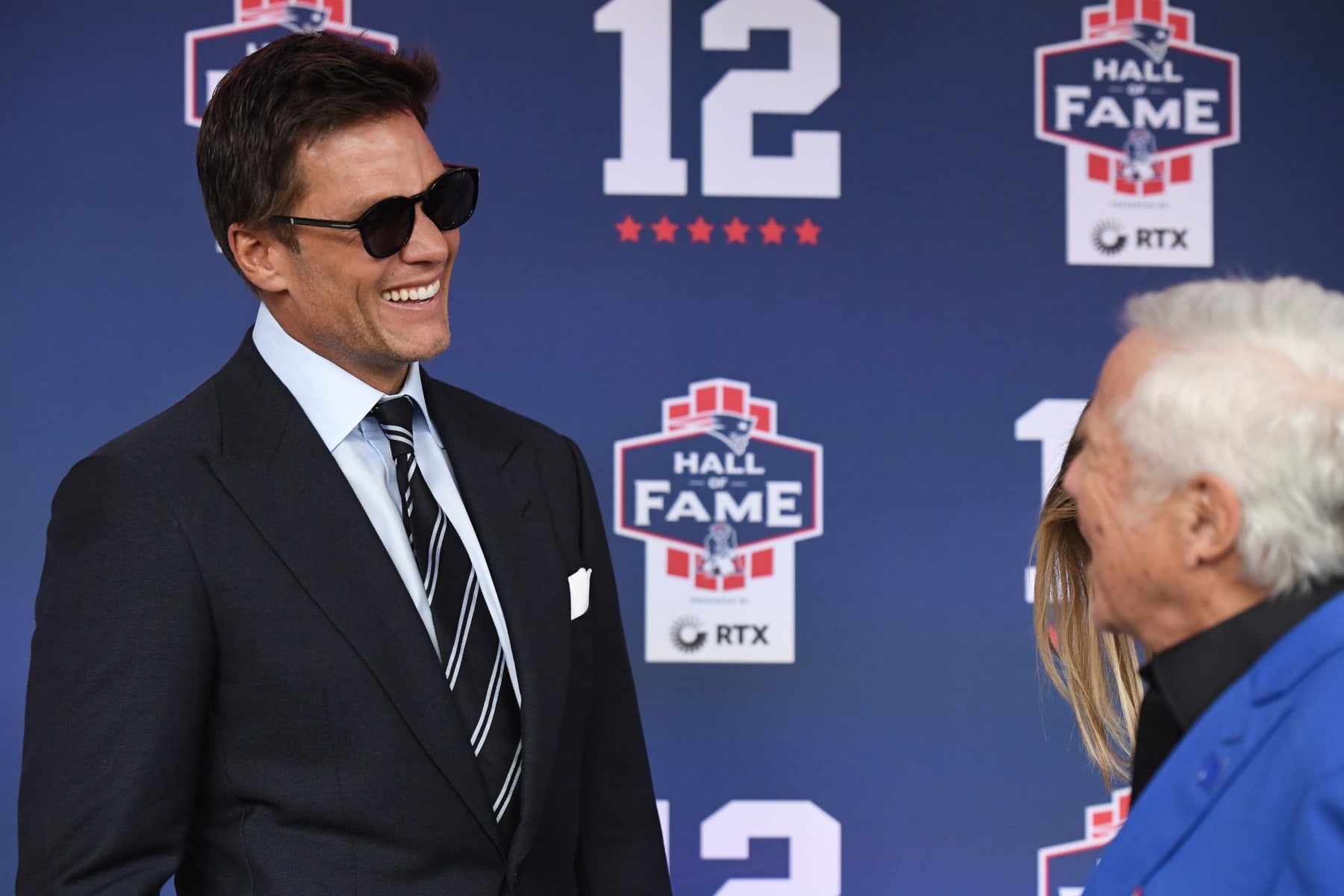 FOXBOROUGH, MASSACHUSETTS - JUNE 12: Tom Brady talks with New England Patriots CEO Robert Kraft during the 2024 Hall of Fame Induction Ceremony for Tom Brady at Gillette Stadium on June 12, 2024 in Foxborough, Massachusetts. (Photo by China Wong/Getty Images)