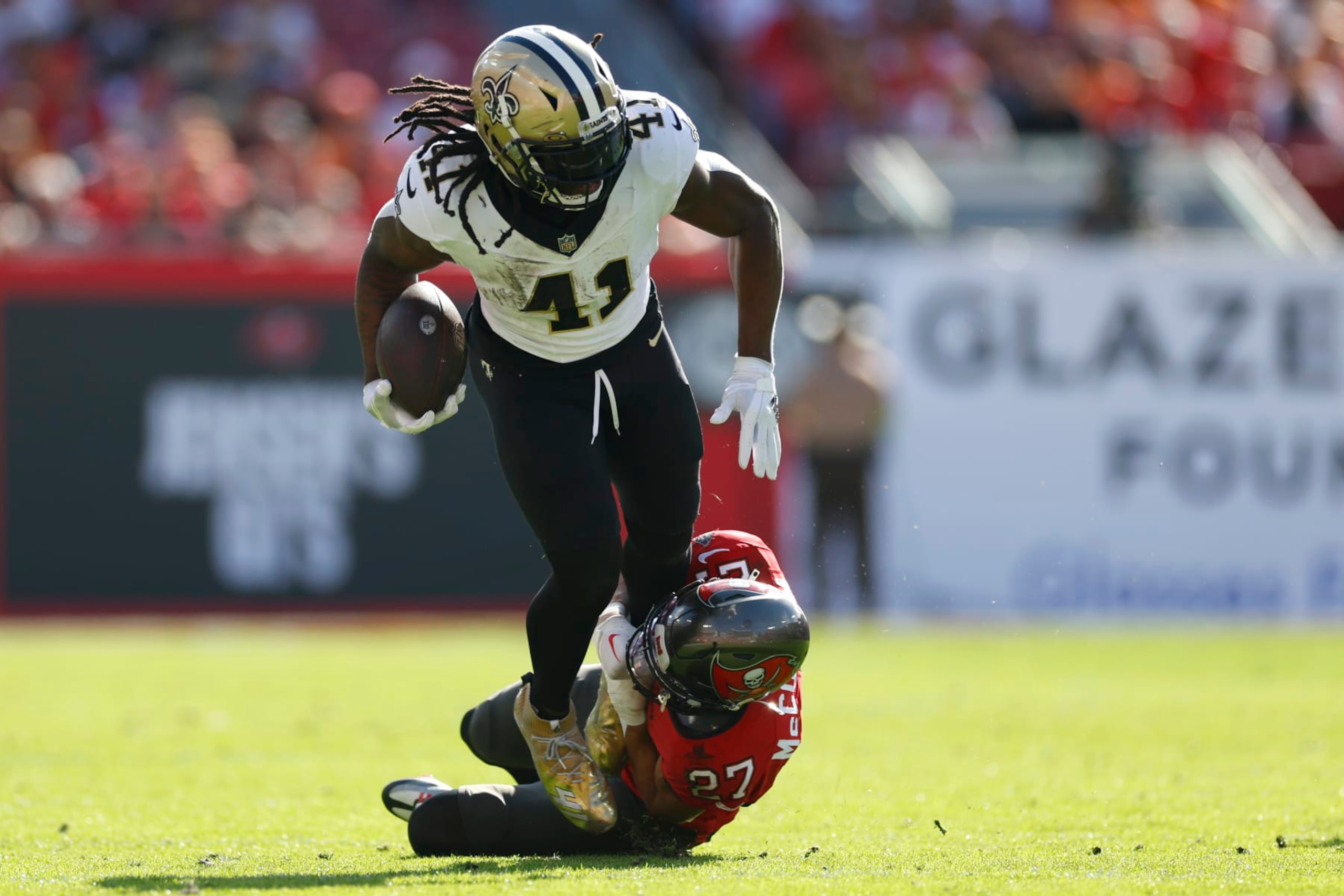 TAMPA, FLORIDA - DECEMBER 31: Alvin Kamara #41 of the New Orleans Saints is tackled by Zyon McCollum #27 of the Tampa Bay Buccaneers during the second quarter at Raymond James Stadium on December 31, 2023 in Tampa, Florida. (Photo by Mike Ehrmann/Getty Images) TAMPA, FLORIDA - DECEMBER 31: Alvin Kamara #41 of the New Orleans Saints is tackled by Zyon McCollum #27 of the Tampa Bay Buccaneers during the second quarter at Raymond James Stadium on December 31, 2023 in Tampa, Florida. (Photo by Mike Ehrmann/Getty Images)