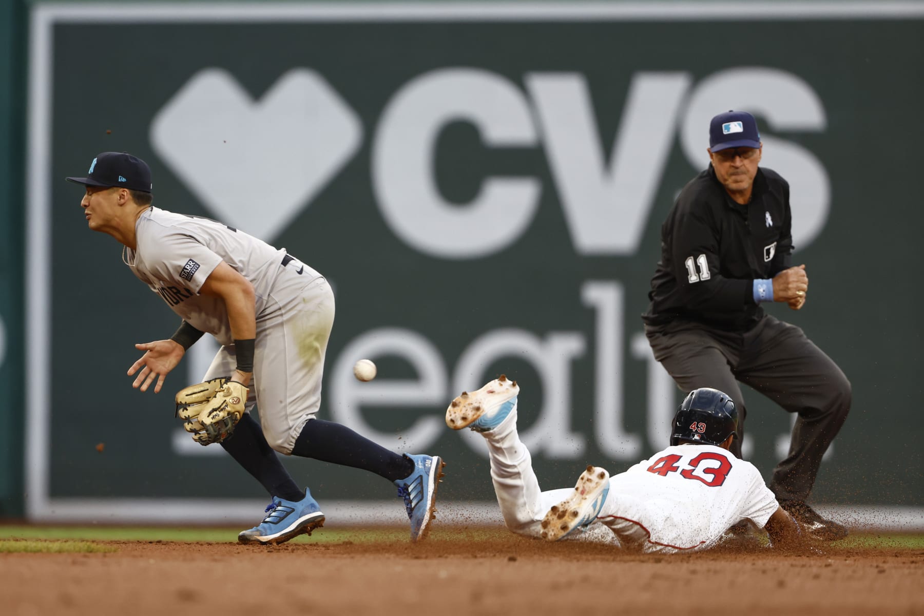 BOSTON, MA - JUNE 16: Anthony Volpe #11 of the New York Yankees can't come up with the throw as Ceddanne Rafaela #43 of the Boston Red Sox steals second base safely during the second inning at Fenway Park on June 16, 2024 in Boston, Massachusetts. (Photo By Winslow Townson/Getty Images)