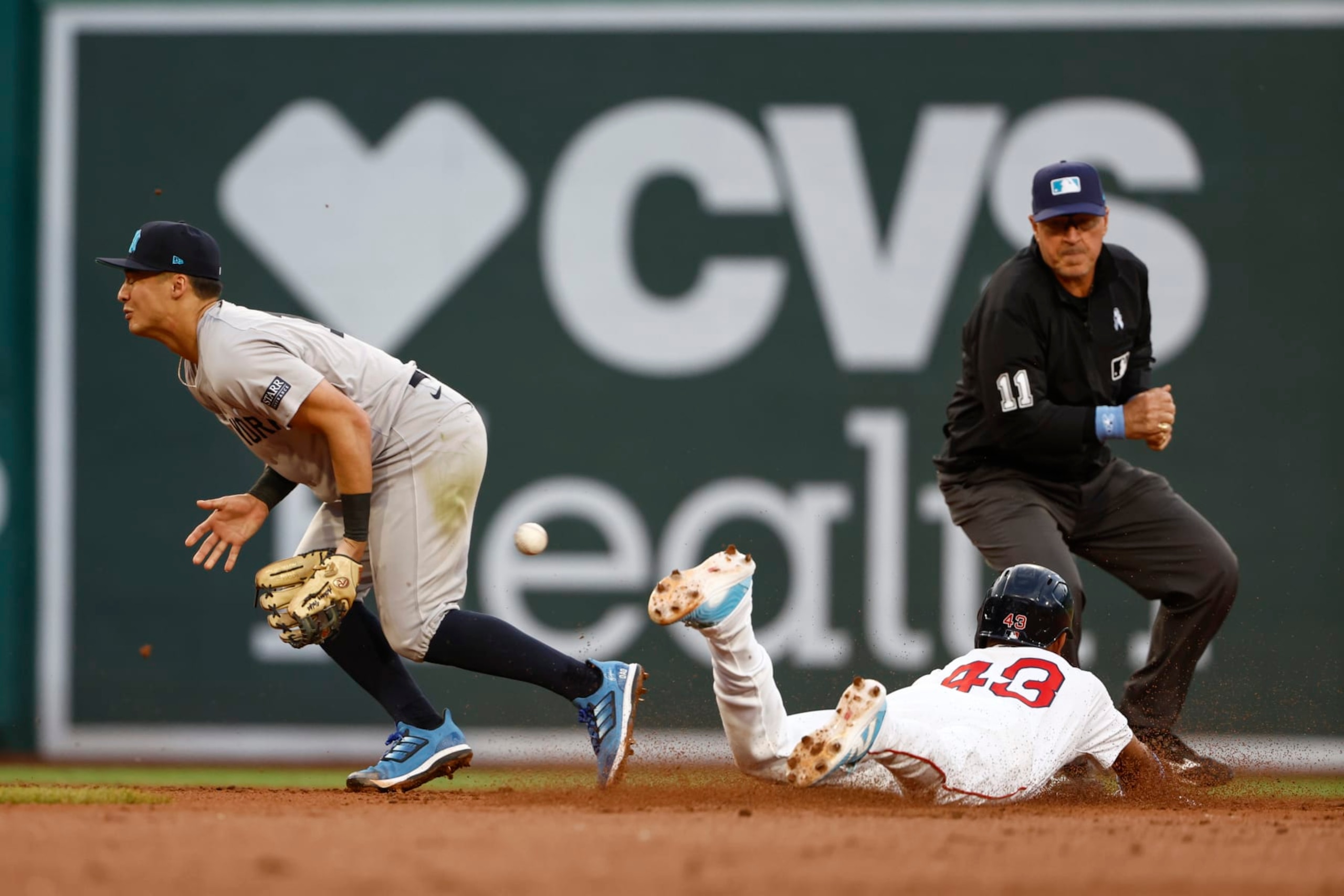 BOSTON, MA - JUNE 16: Anthony Volpe #11 of the New York Yankees can't come up with the throw as Ceddanne Rafaela #43 of the Boston Red Sox steals second base safely during the second inning at Fenway Park on June 16, 2024 in Boston, Massachusetts. (Photo By Winslow Townson/Getty Images)