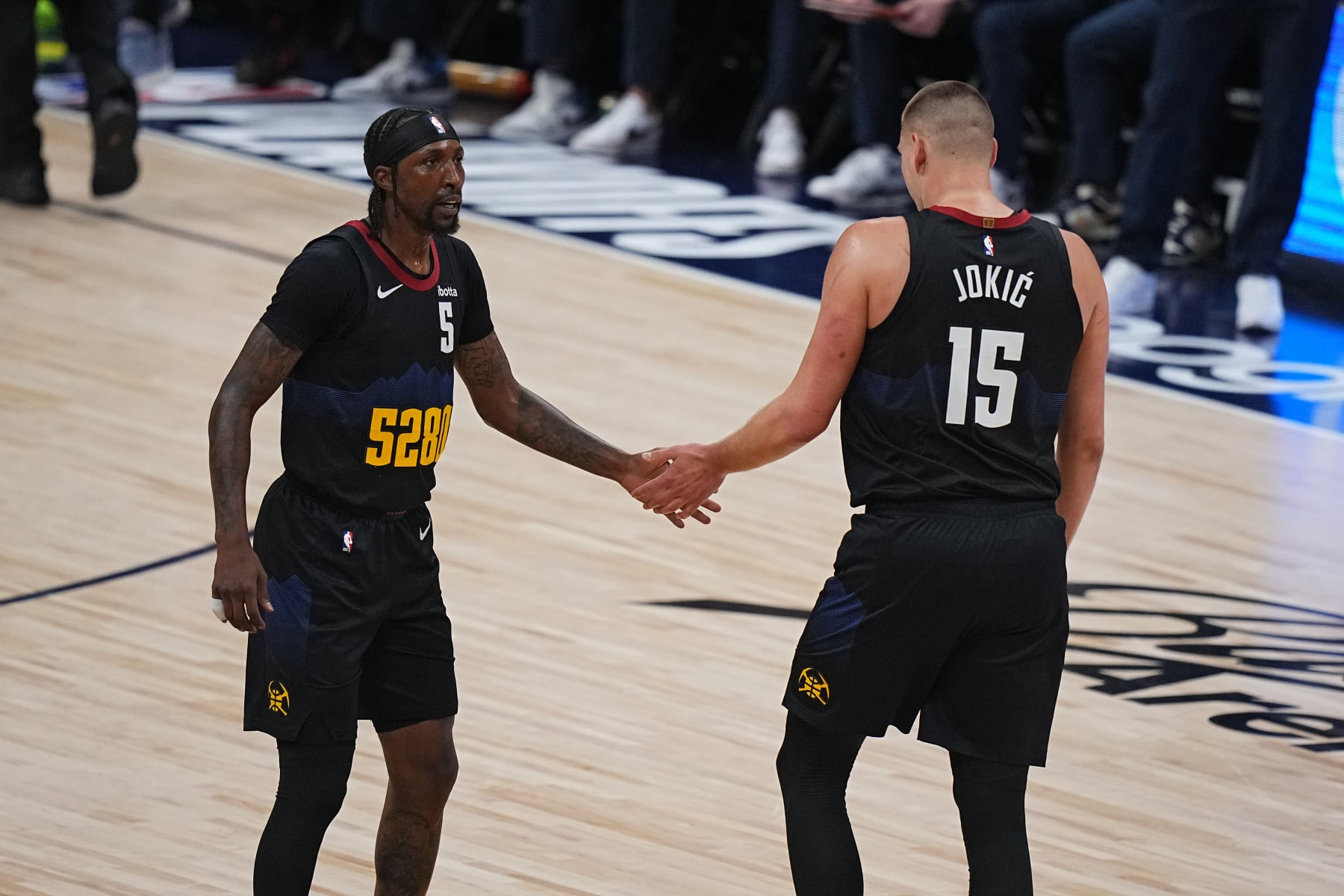 DENVER, CO - MAY 14: Kentavious Caldwell-Pope #5 and Nikola Jokic #15 of the Denver Nuggets react against the Minnesota Timberwolves during Round 2 Game 5 of the 2024 NBA Playoffs on May 14, 2024 at the Ball Arena in Denver, Colorado. NOTE TO USER: User expressly acknowledges and agrees that, by downloading and/or using this Photograph, user is consenting to the terms and conditions of the Getty Images License Agreement. Mandatory Copyright Notice: Copyright 2024 NBAE (Photo by Bart Young/NBAE via Getty Images)