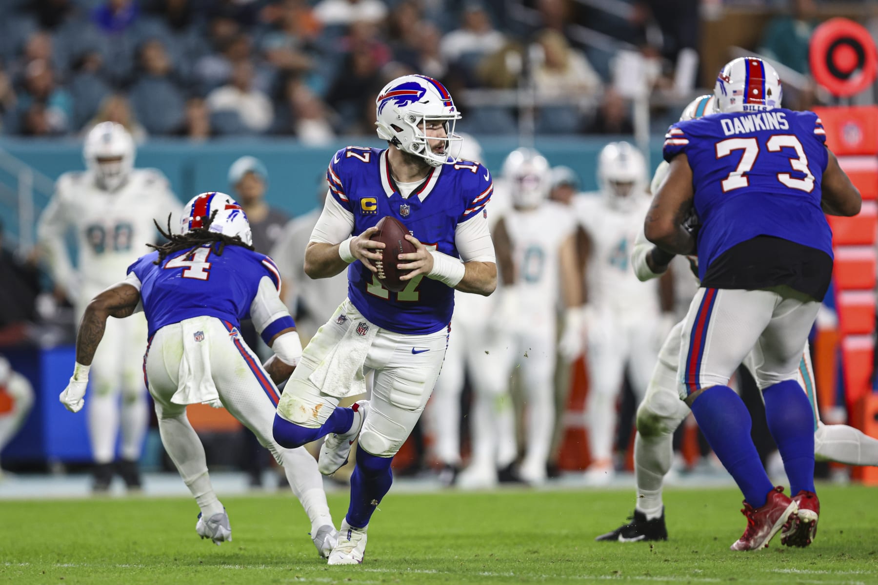 MIAMI GARDENS, FL - JANUARY 07: Josh Allen #17 of the Buffalo Bills scrambles out of the pocket during an NFL football game against the Miami Dolphins at Hard Rock Stadium on January 7, 2024 in Miami Gardens, Florida. (Photo by Perry Knotts/Getty Images)