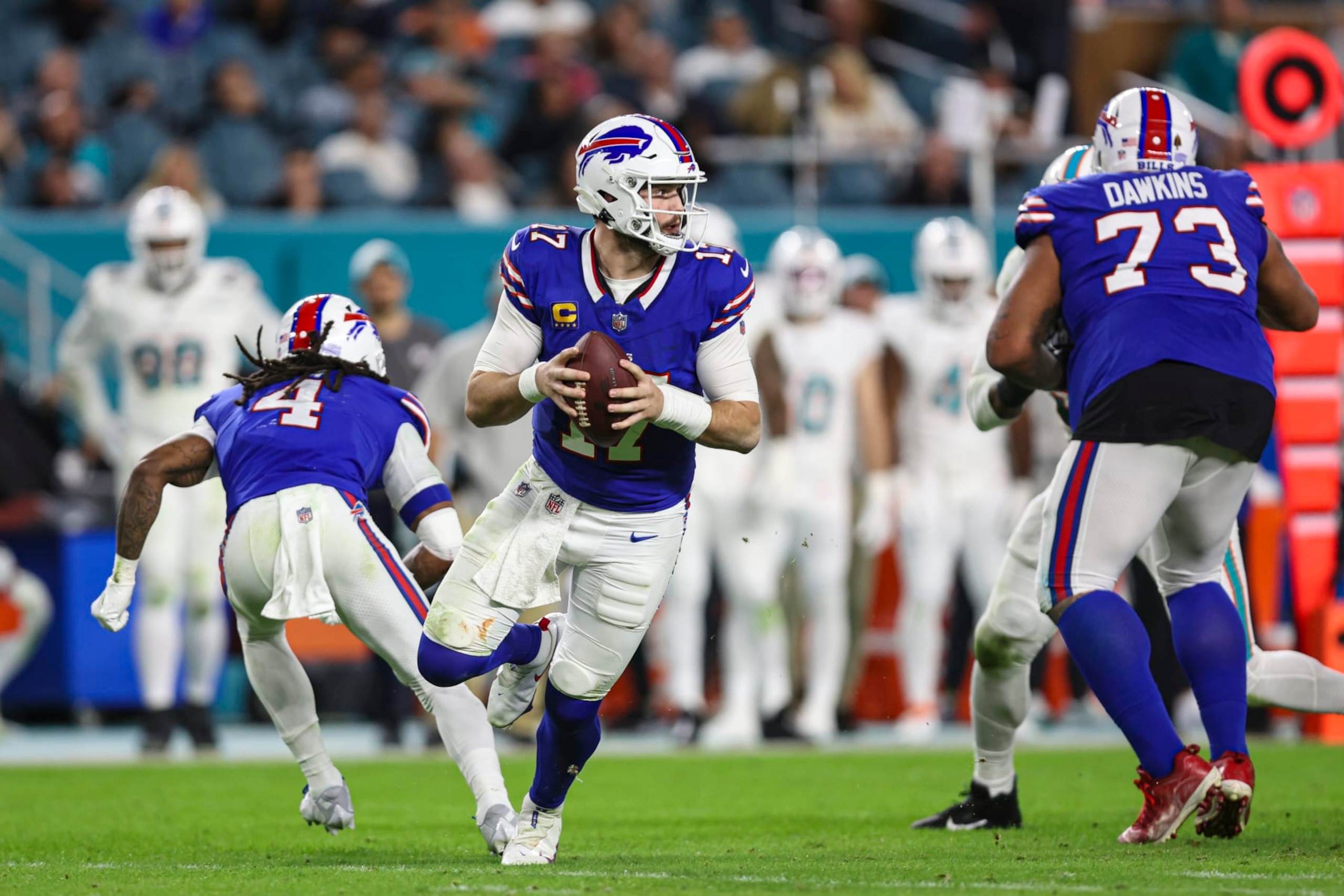 MIAMI GARDENS, FL - JANUARY 07: Josh Allen #17 of the Buffalo Bills scrambles out of the pocket during an NFL football game against the Miami Dolphins at Hard Rock Stadium on January 7, 2024 in Miami Gardens, Florida. (Photo by Perry Knotts/Getty Images)