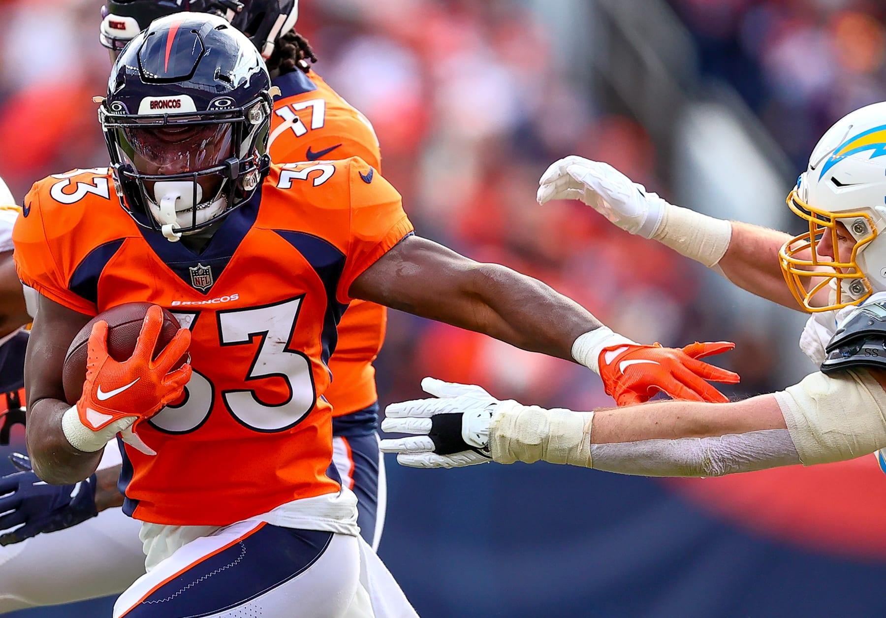 DENVER, CO - DECEMBER 31: Denver Broncos running back Javonte Williams (33) avoids get stopped during an NFL game between the Los Angeles Chargers and the Denver Broncos on December 31, 2023 at Empower Field at Mile High in Denver, CO. (Photo by Steve Nurenberg/Icon Sportswire via Getty Images)